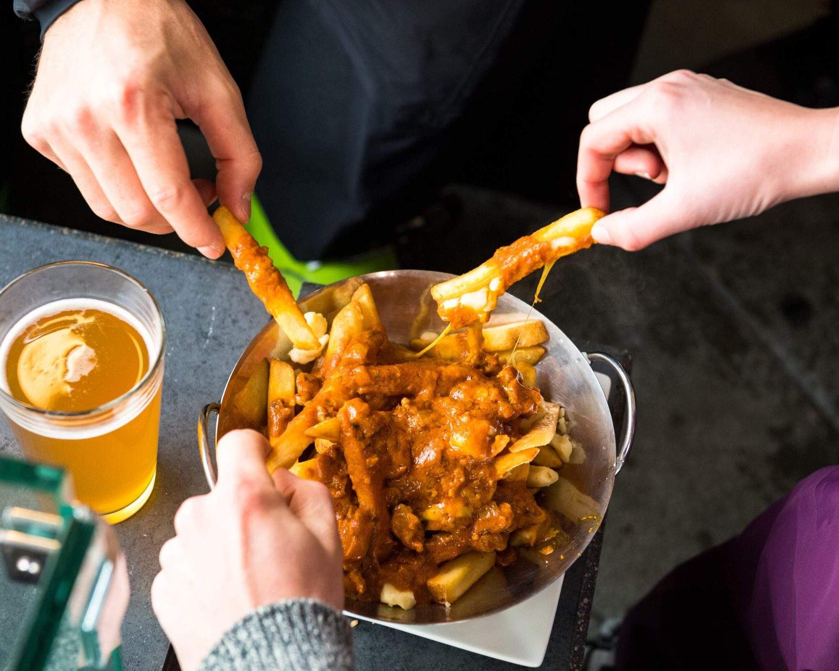 Apres ski foods. Beer and poutine at the bar. Savoury pub foods.
