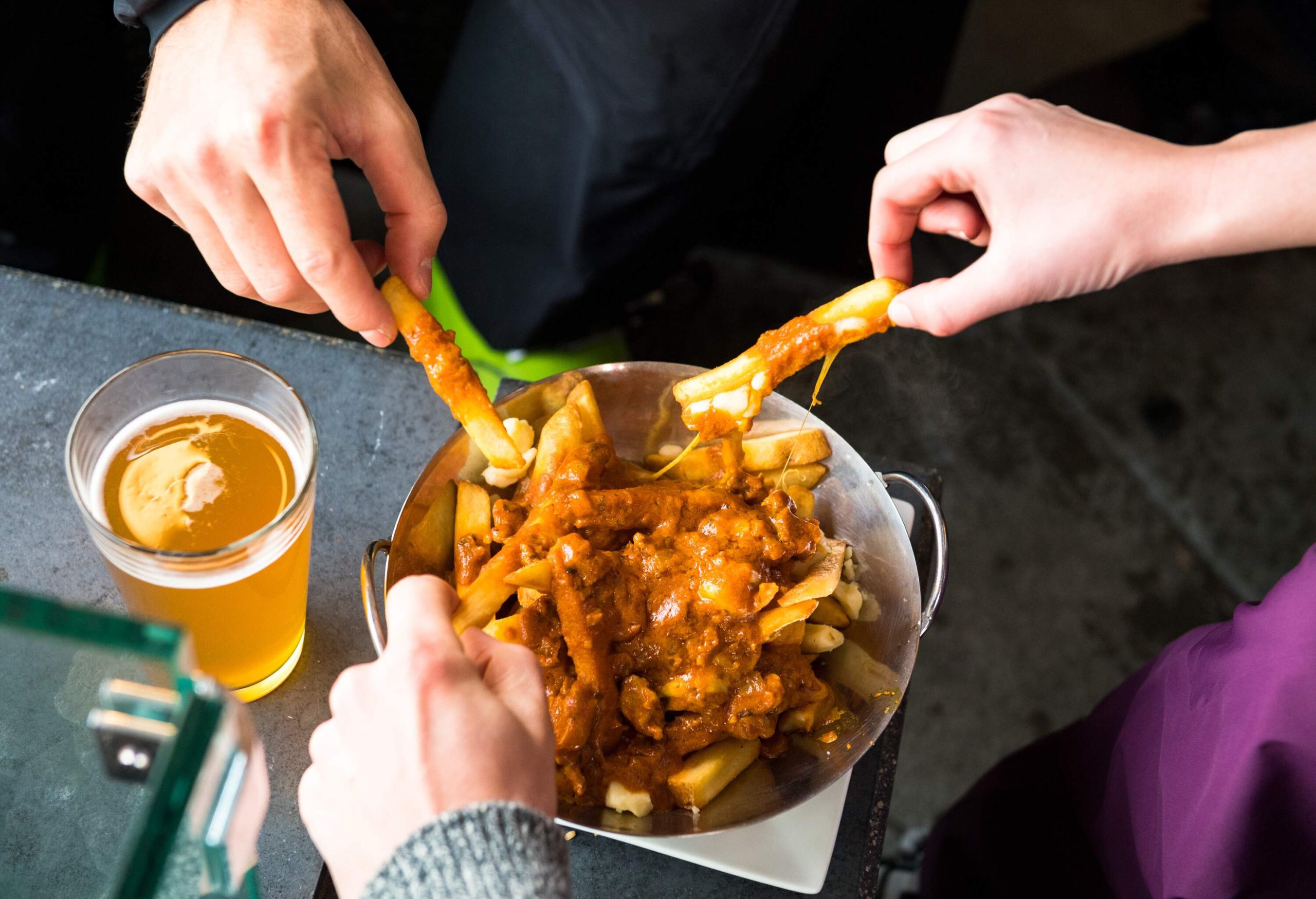 Apres ski foods. Beer and poutine at the bar. Savoury pub foods.