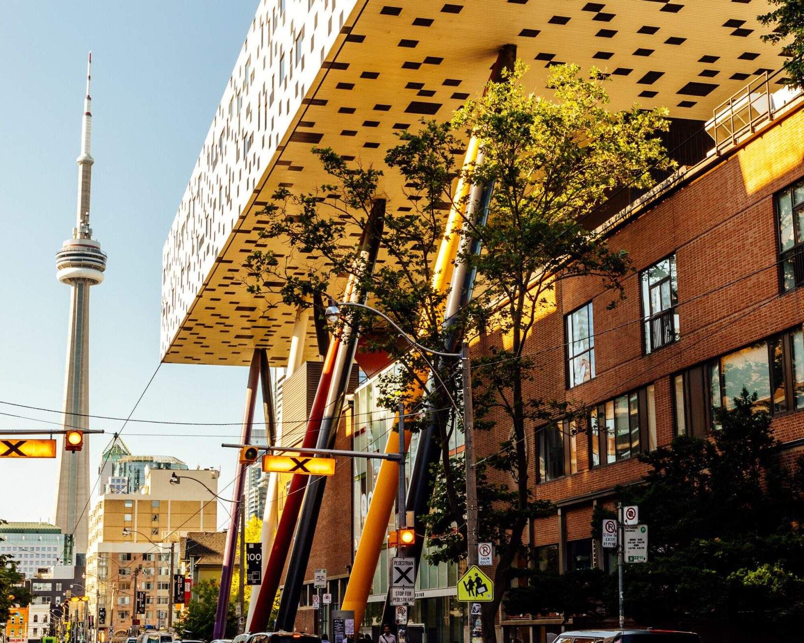 The CN Tower and the unique main building of OCAD University tower over Toronto