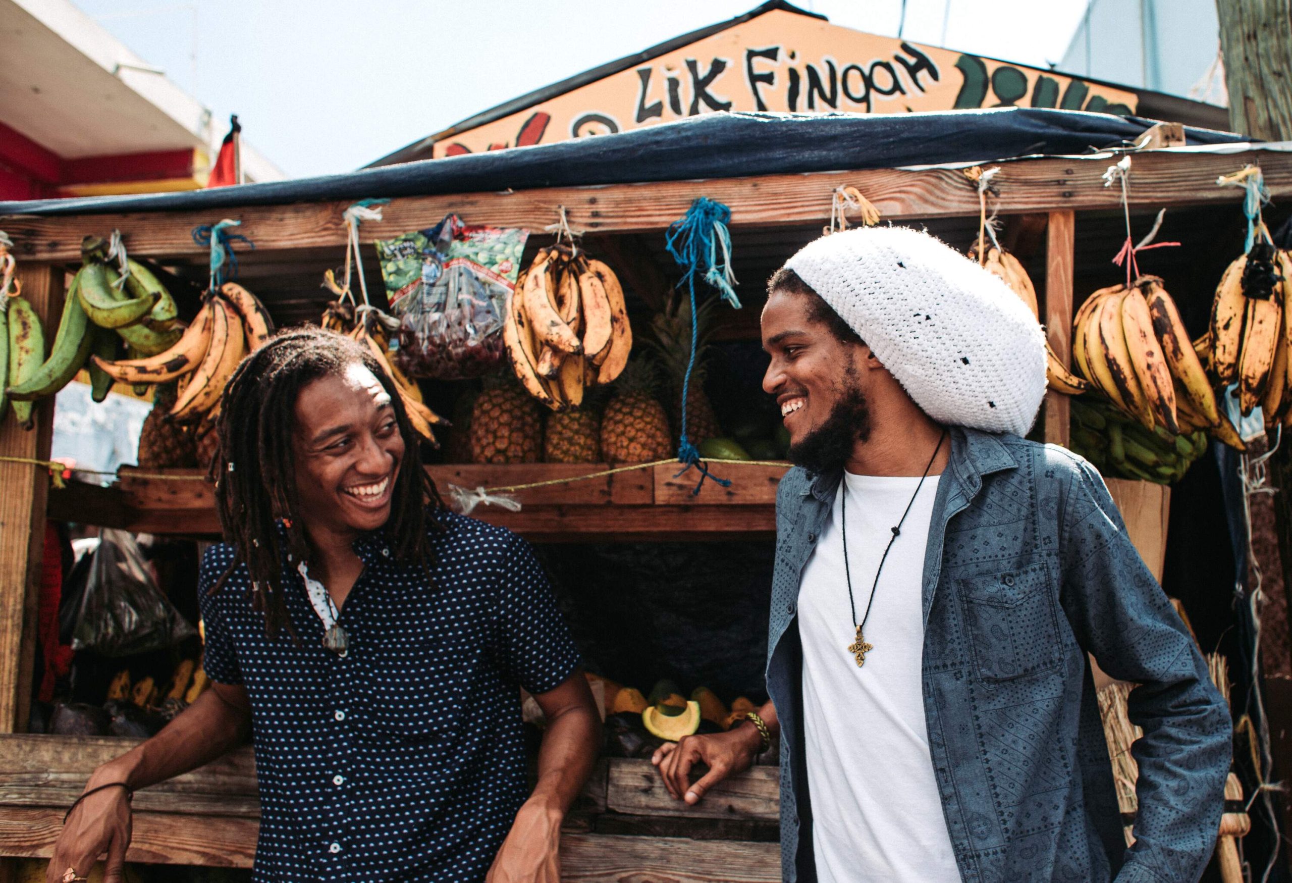 two Rastaman with Fruits at a stall in Papine, Kingston