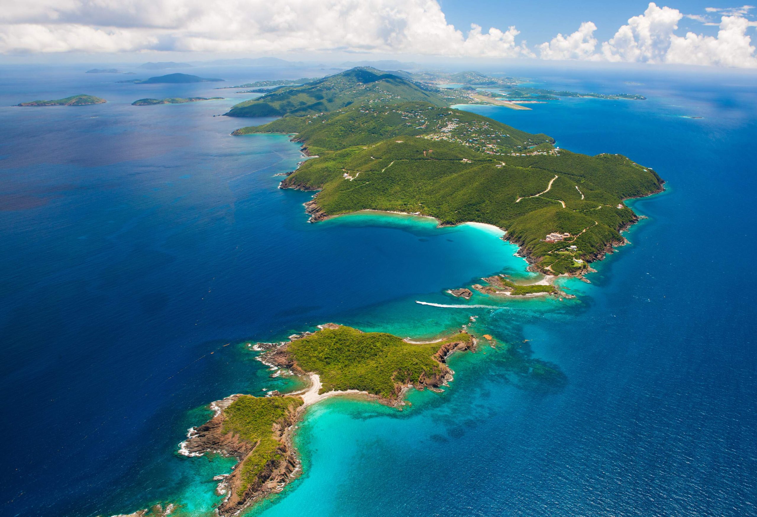 An awe-inspiring aerial view captures the vibrant West End of St. Thomas in the US Virgin Islands, showcasing its coastal beauty and inviting exploration of tropical paradise.