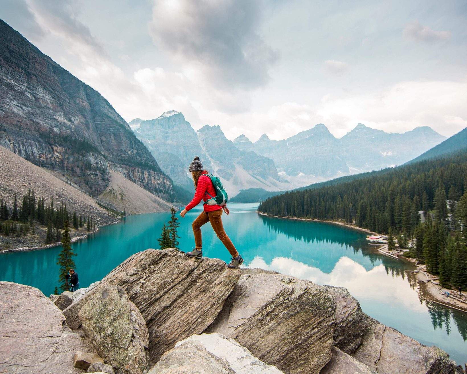A hiker walks on a rocky hill