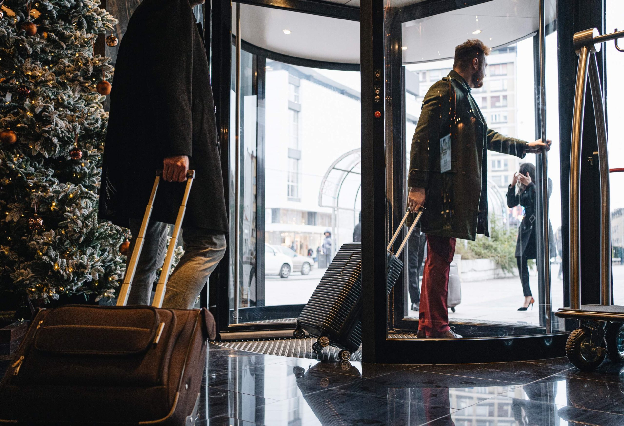 Businessmen leaving a hotel through a revolving door.