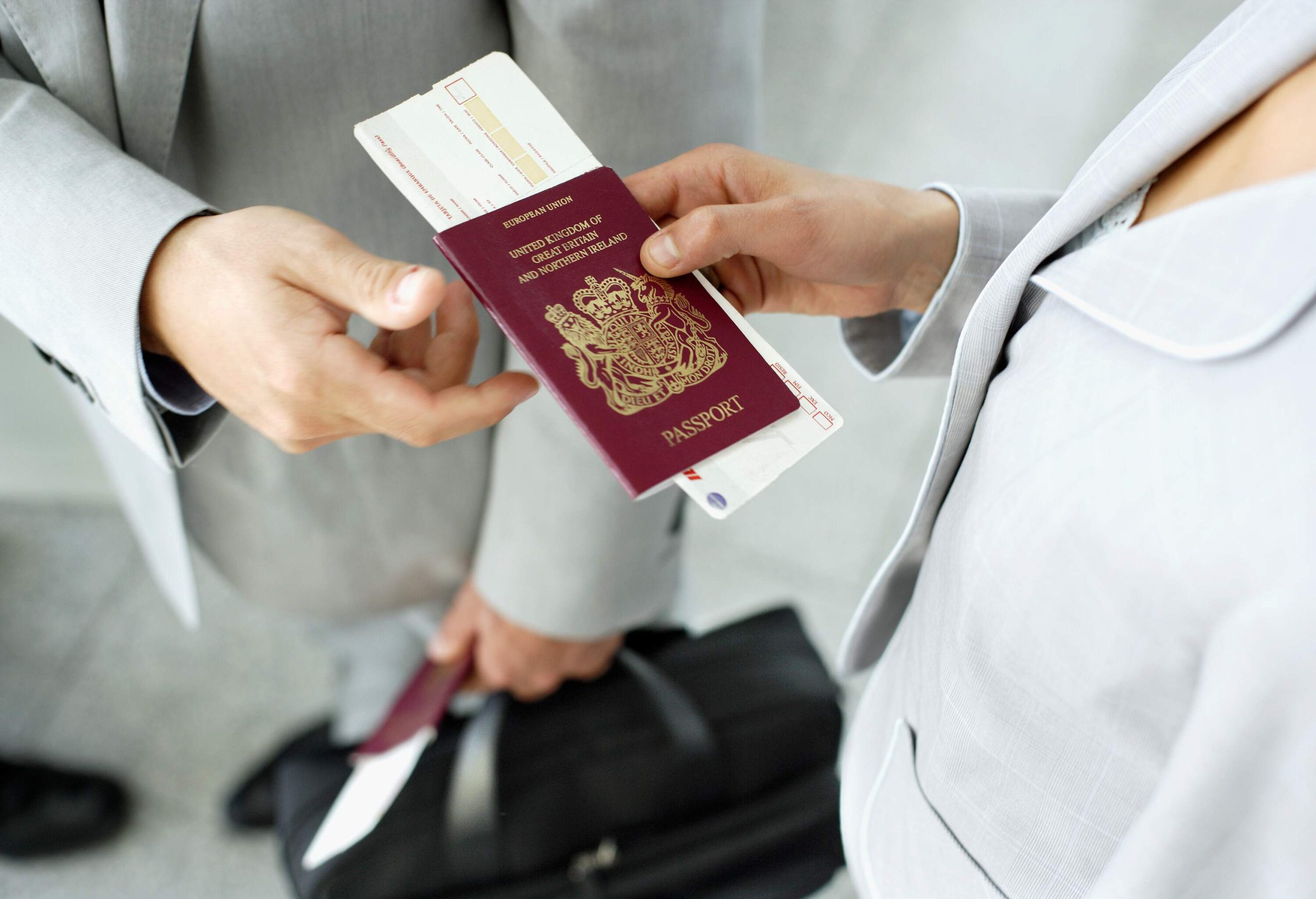 Person holding passport.