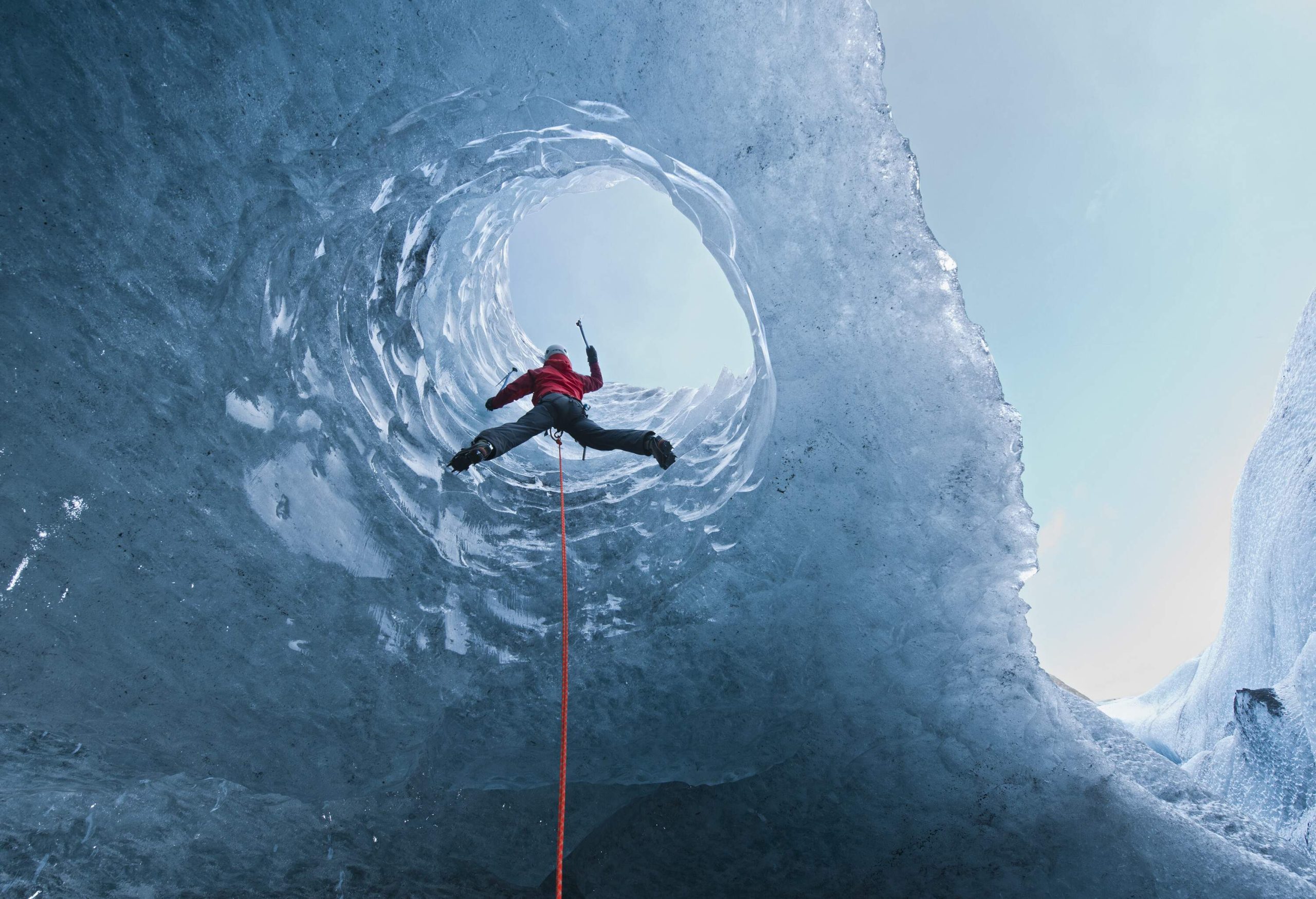 Lower view of person climbing ice