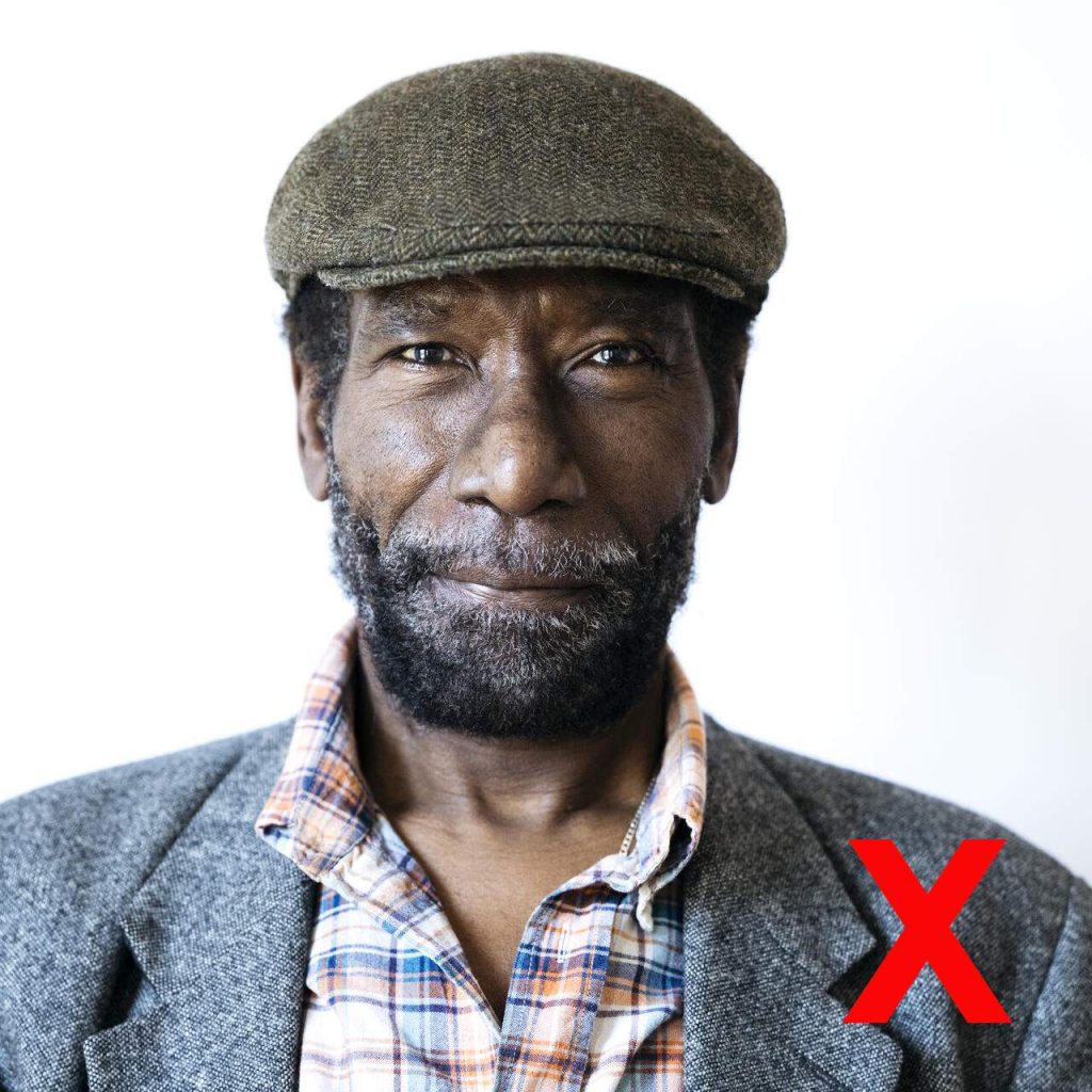 Example of non-valid passport photo, a man wearing a hat
