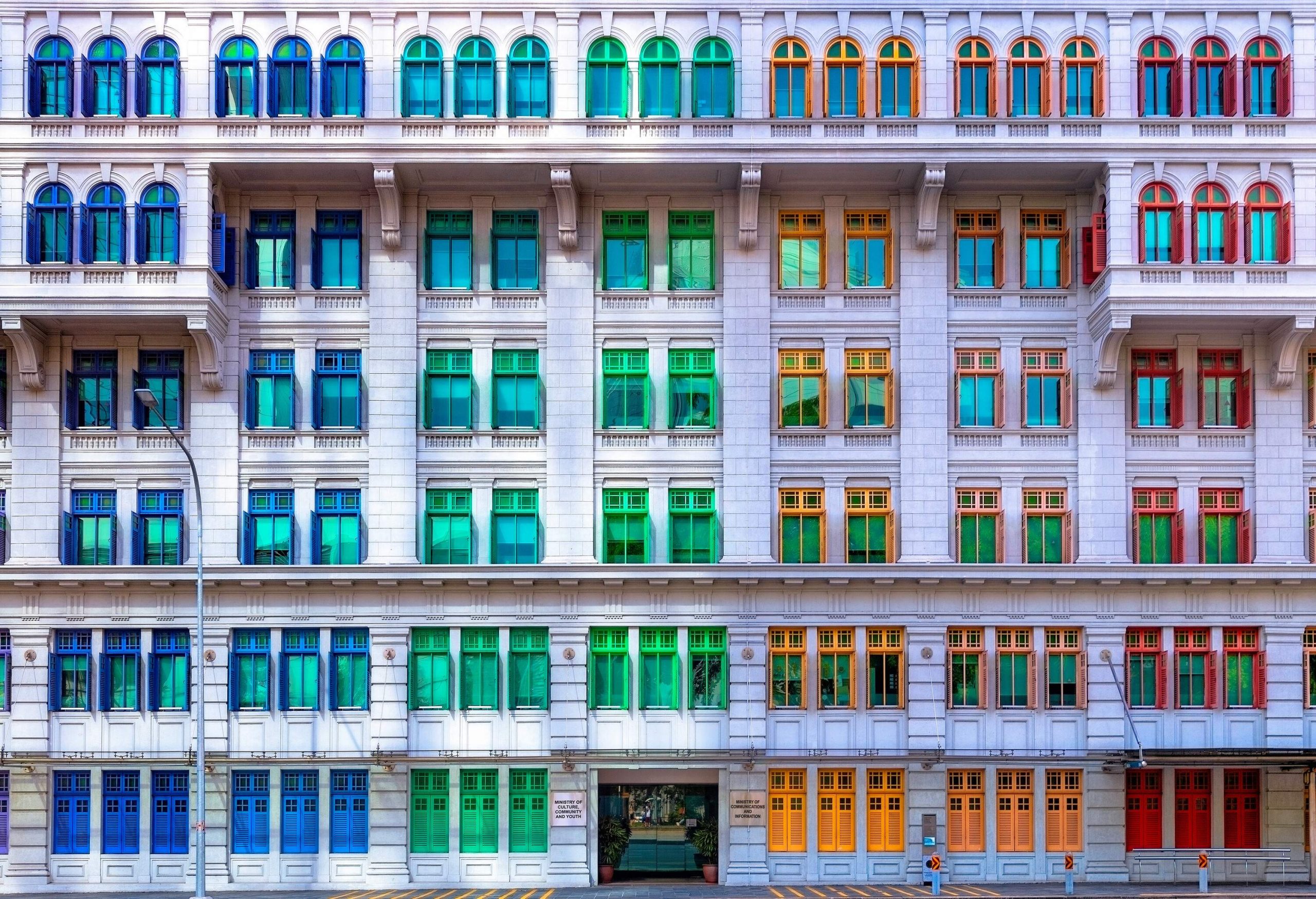 Façade of a building with colourful glass windows.