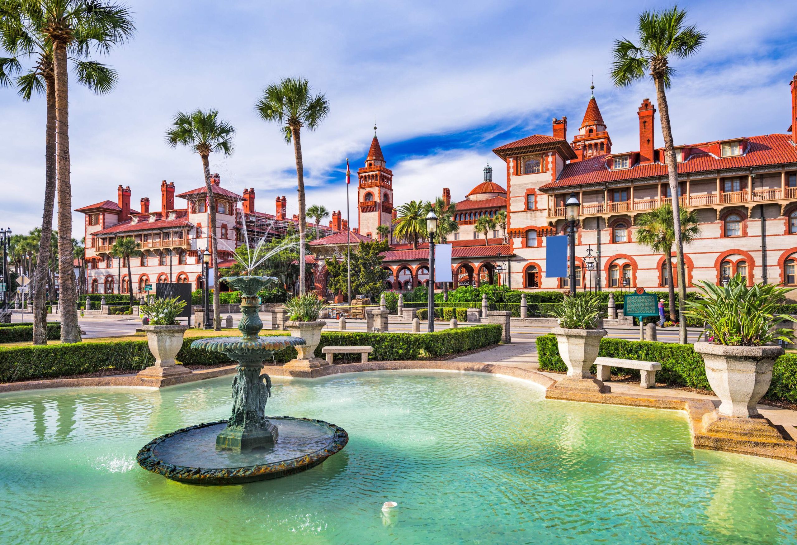 A beautiful and soothing fountain in the courtyard in front of Spanish Renaissance architecture buildings.