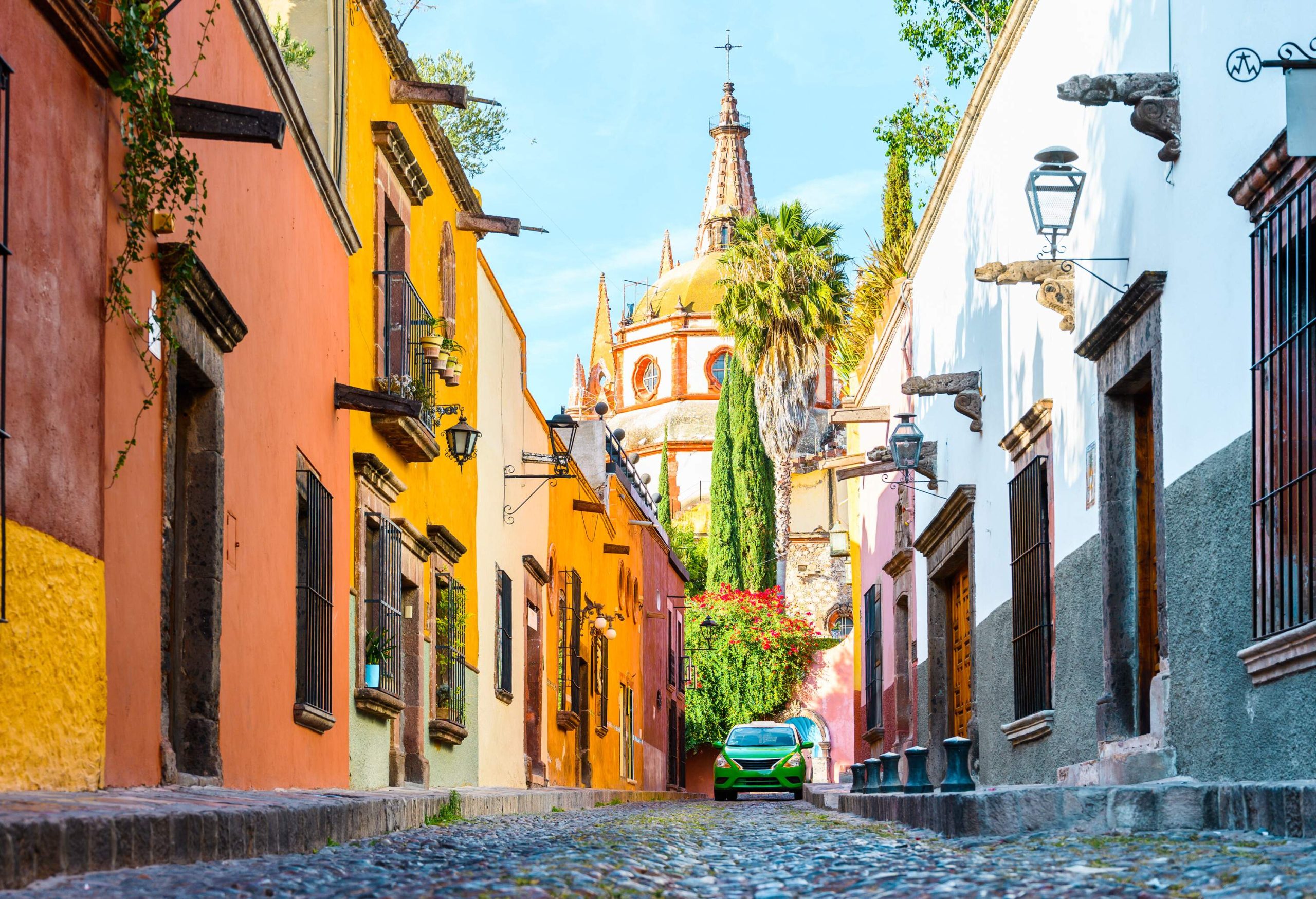 A cobblestone street adorned with a vibrant array of colourful buildings.
