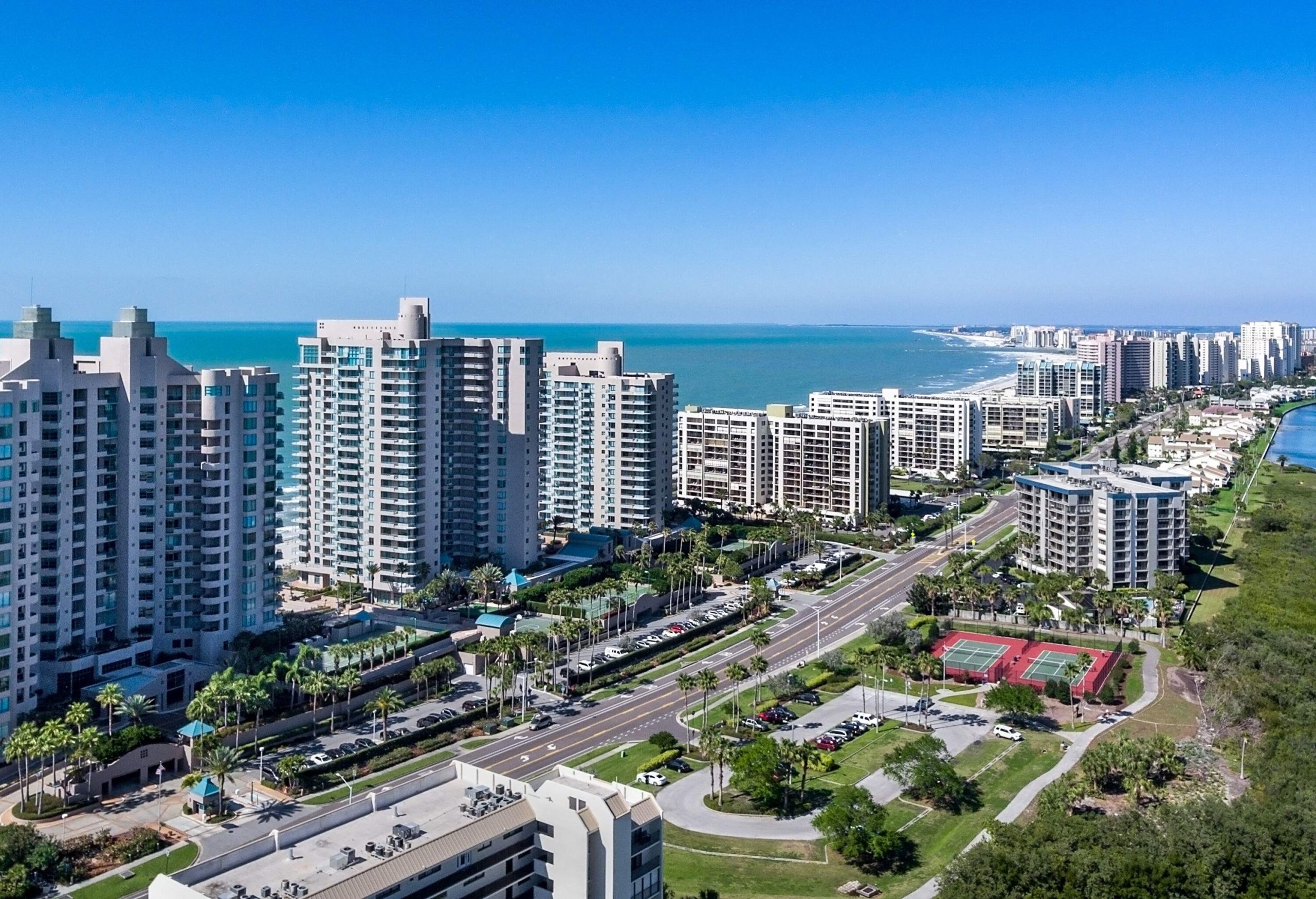 The Clearwater Beach skyline features a blend of modern high-rise buildings, showcasing a coastal cityscape against the backdrop of pristine beaches and the sparkling waters of Florida.
