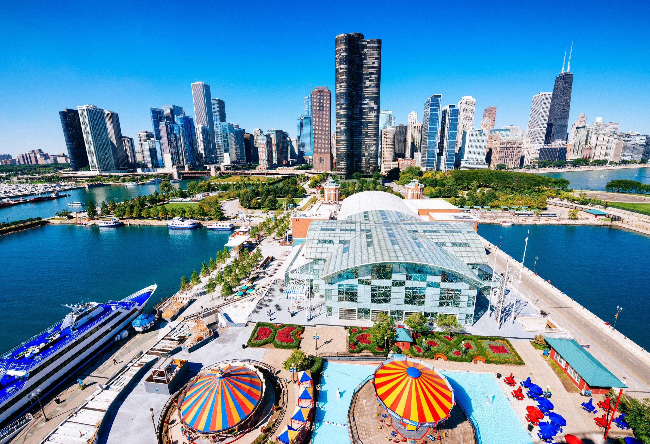 A theme park that is situated next to the pier and enclosed by a lake connects to the city of skyscrapers.