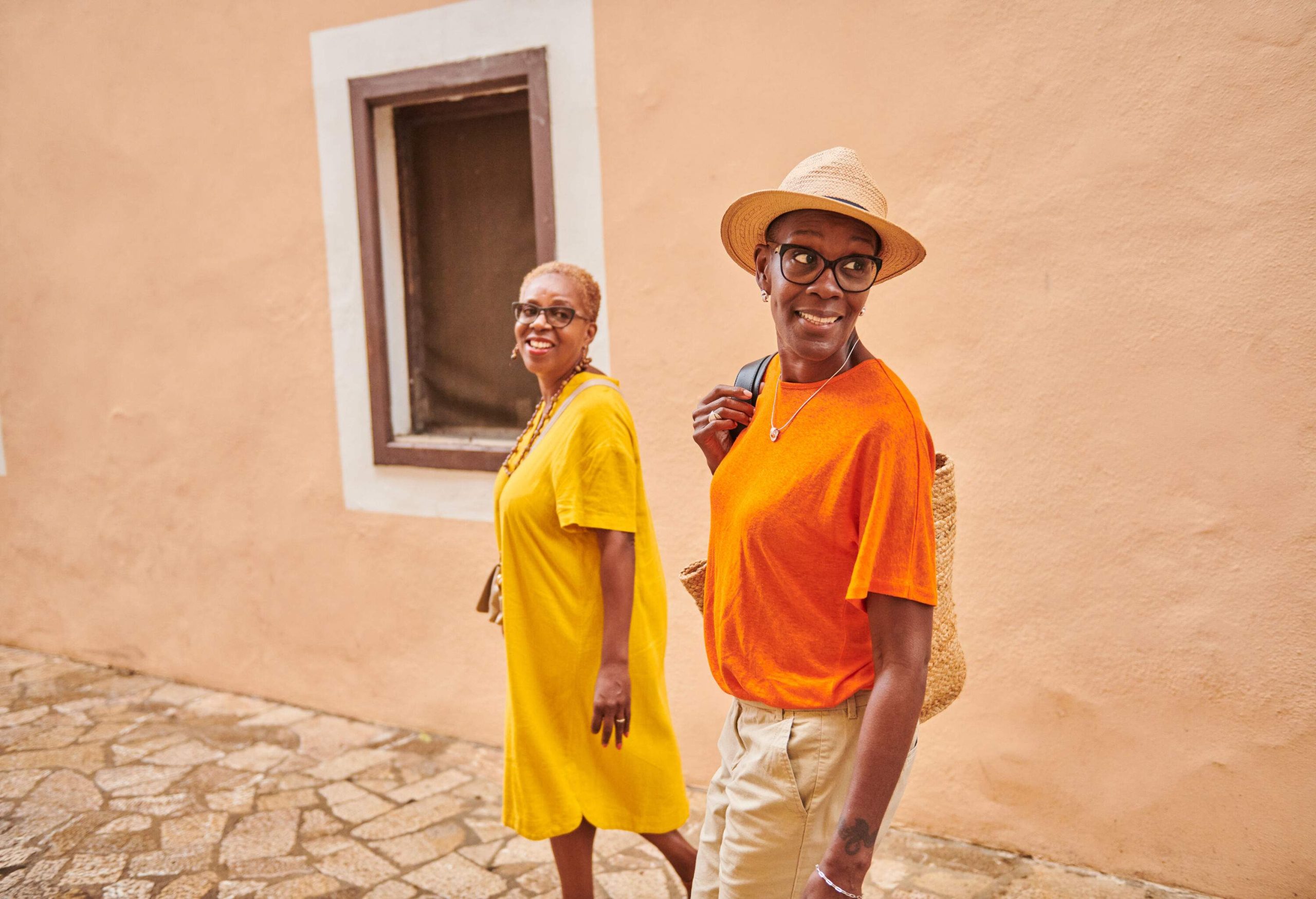 Smiling and looking around a traditional old town in Majorca Spain.