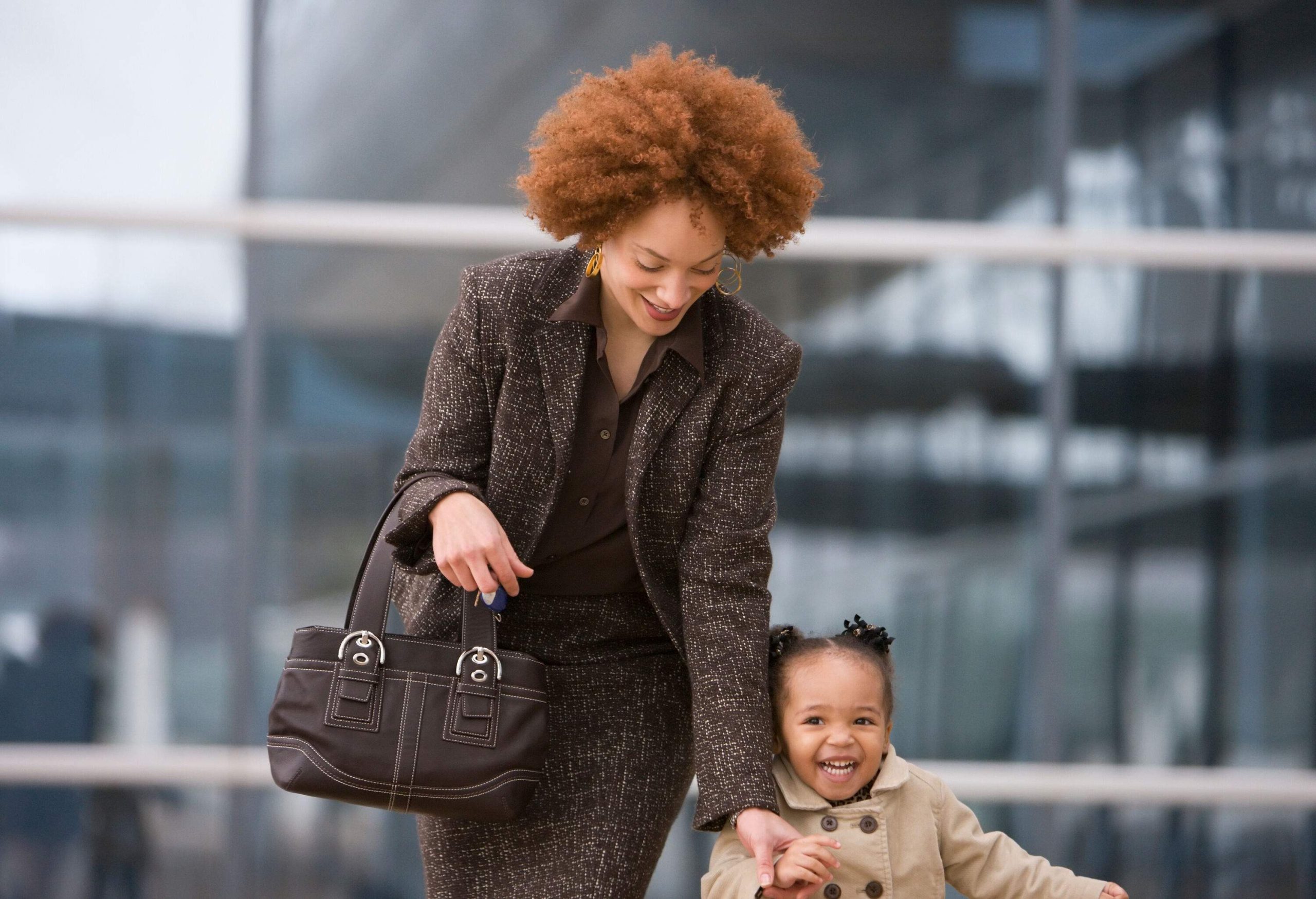 A happy mother reaches the hands of her running daughter.