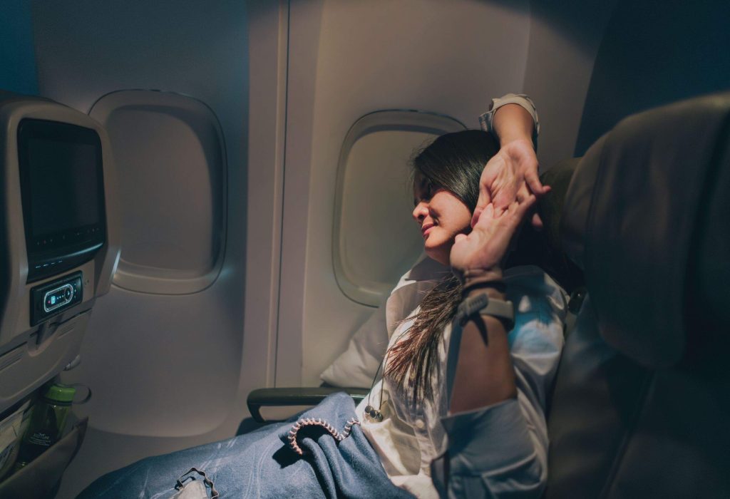 Woman stretching on long haul flight