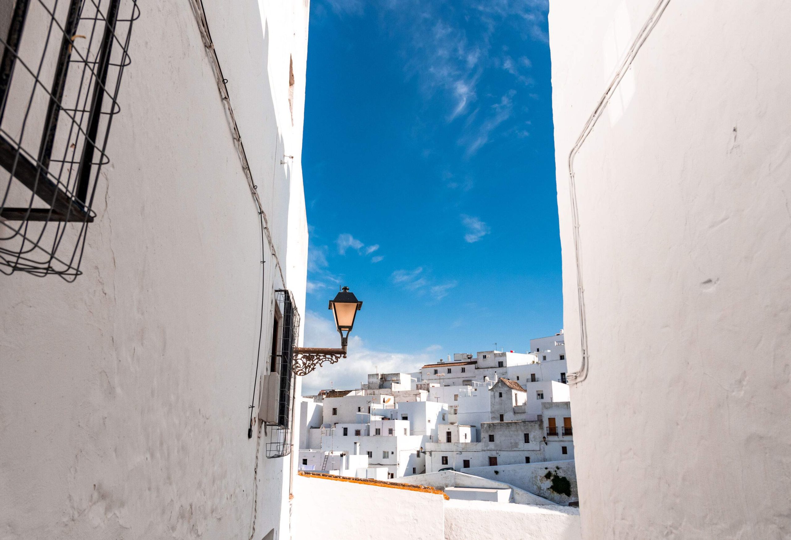 A village with whitewashed houses seen from across a narrow street.