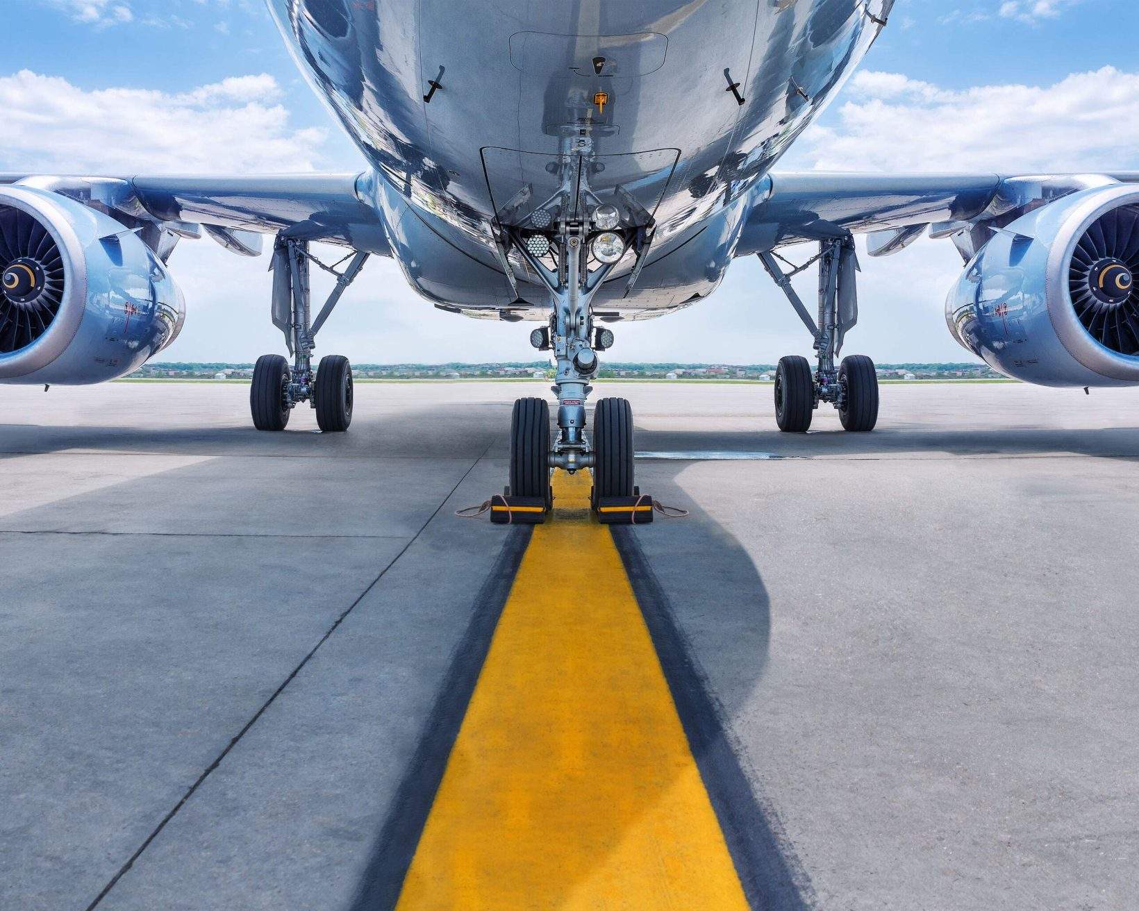 Turbines of an aircraft idling steadily over the runway.