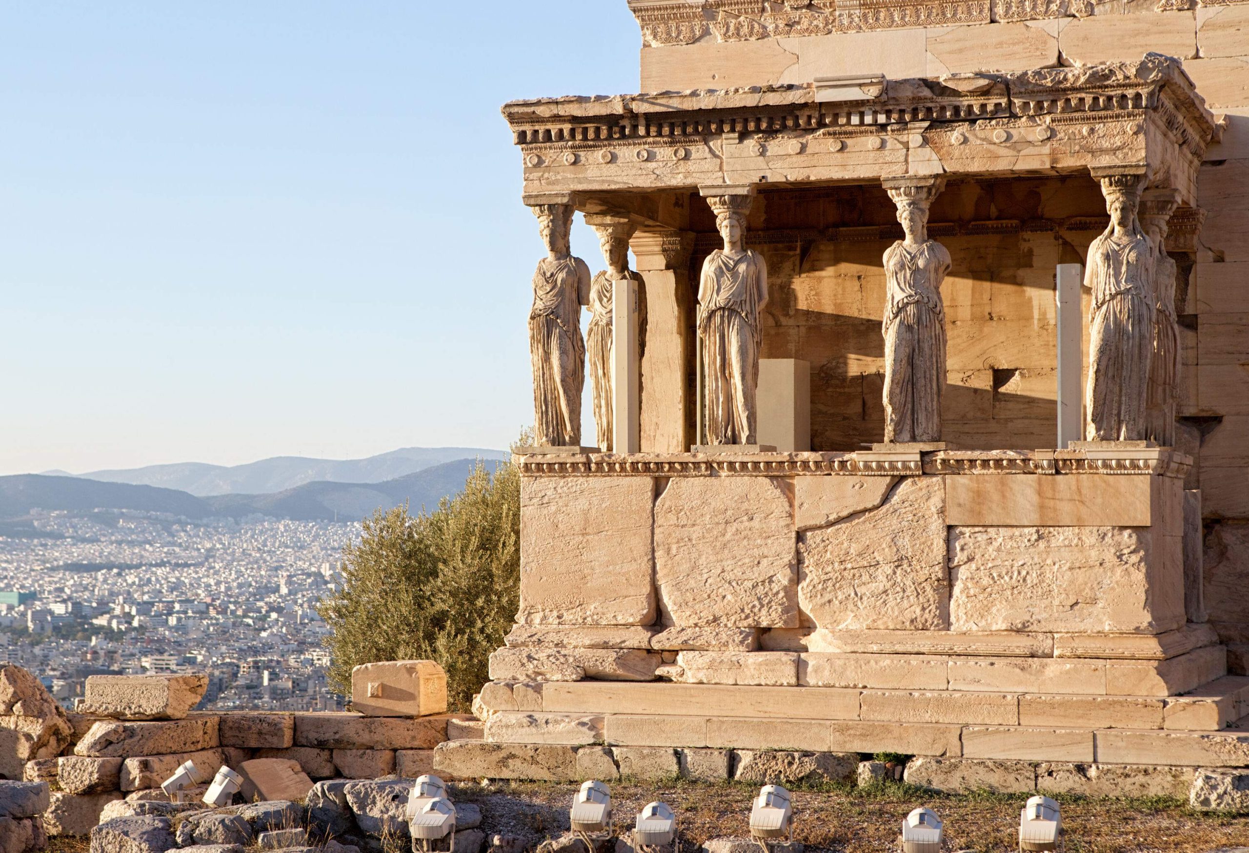 Six statues of maidens on the porch of an ancient temple in an old ruined building of the Acropolis.