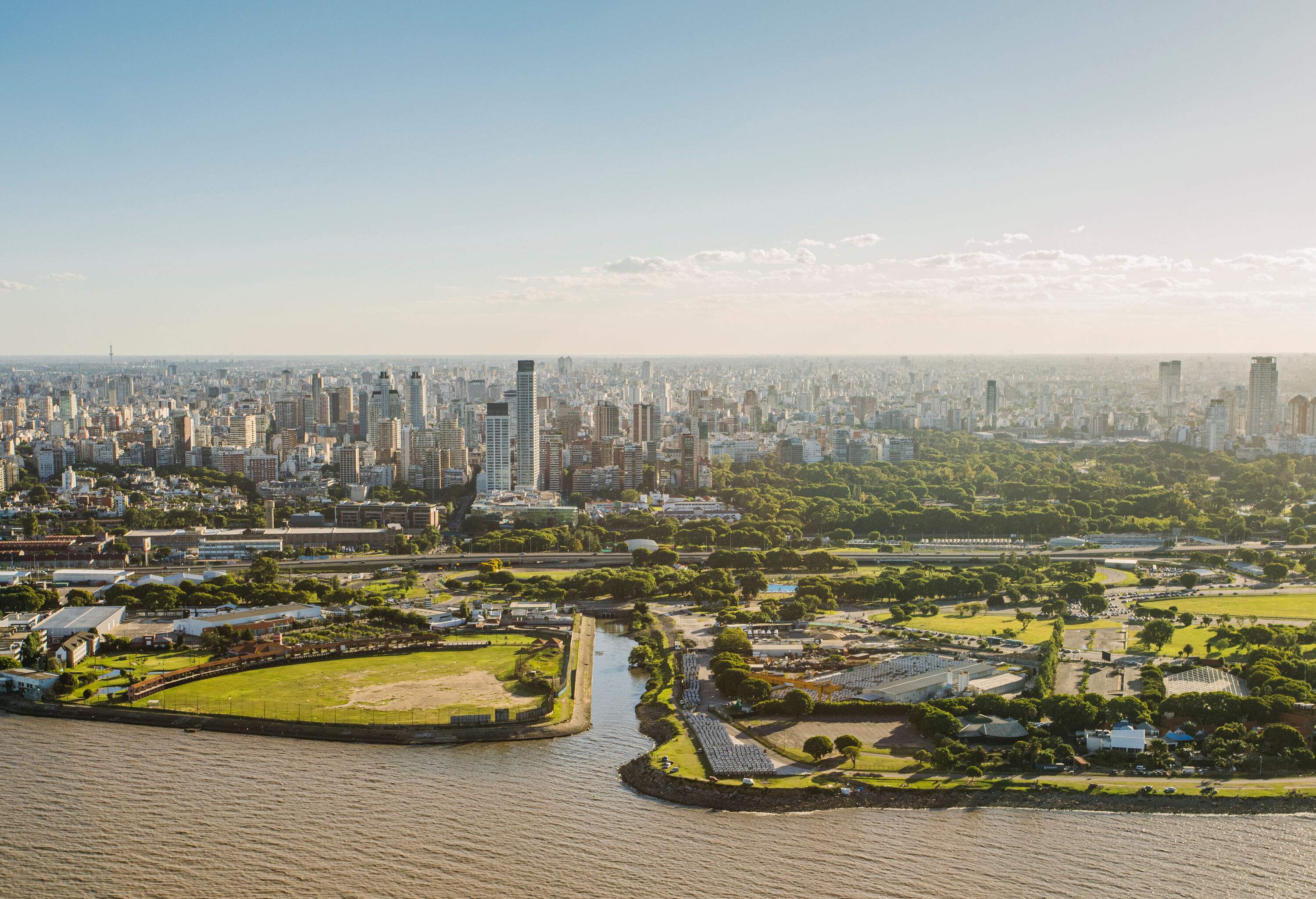 The captivating cityscape of Buenos Aires emerges along the tranquil waters, where the vibrant energy of the metropolis meets the serene embrace of the river.