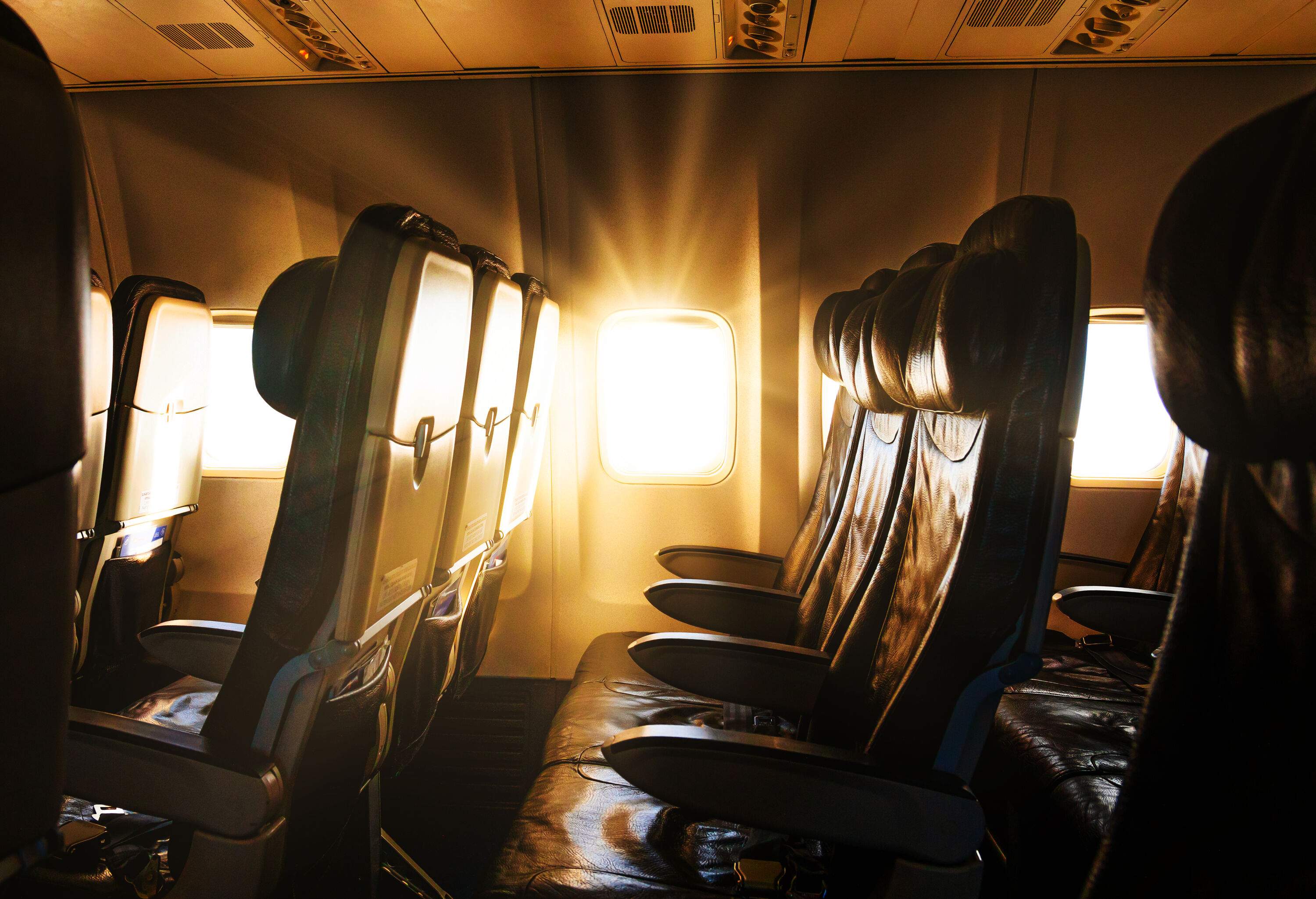 The piercing rays of the sun beaming through the airplane window.