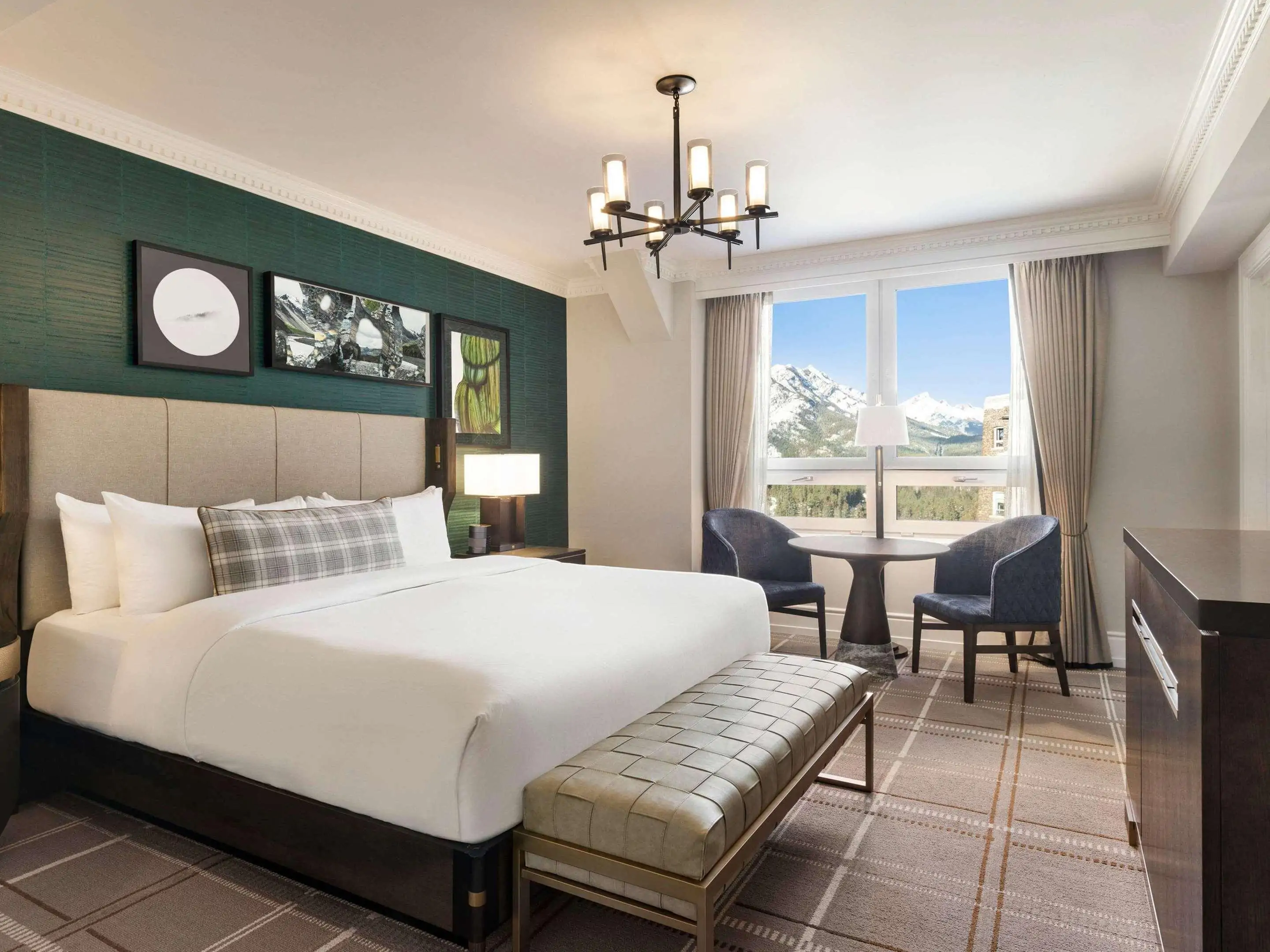 Cozy moiuntain hotel room with luxurious details overlooking snow-capped mountain peaks