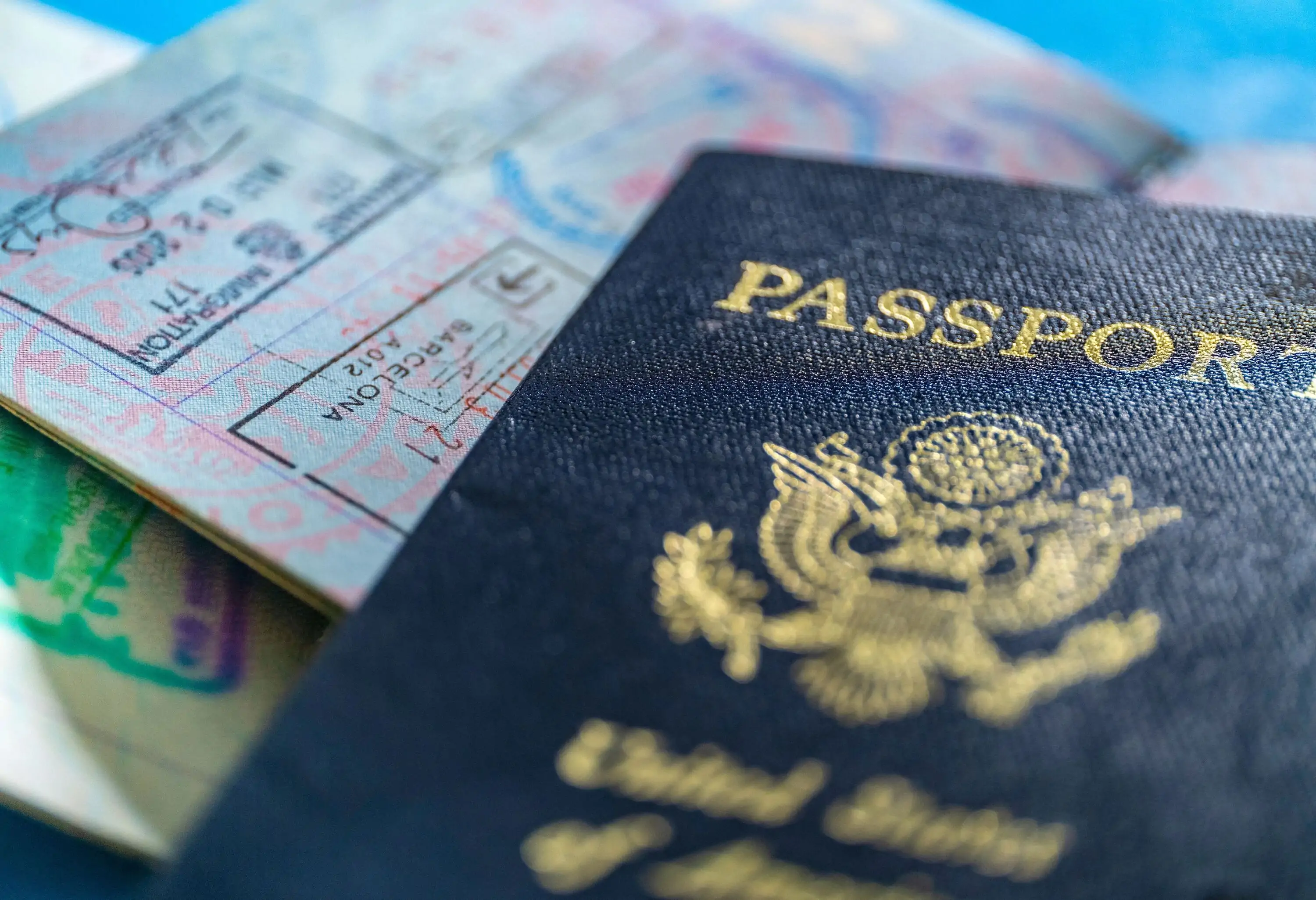 Close up of US passports with cover and one open to visa stamps