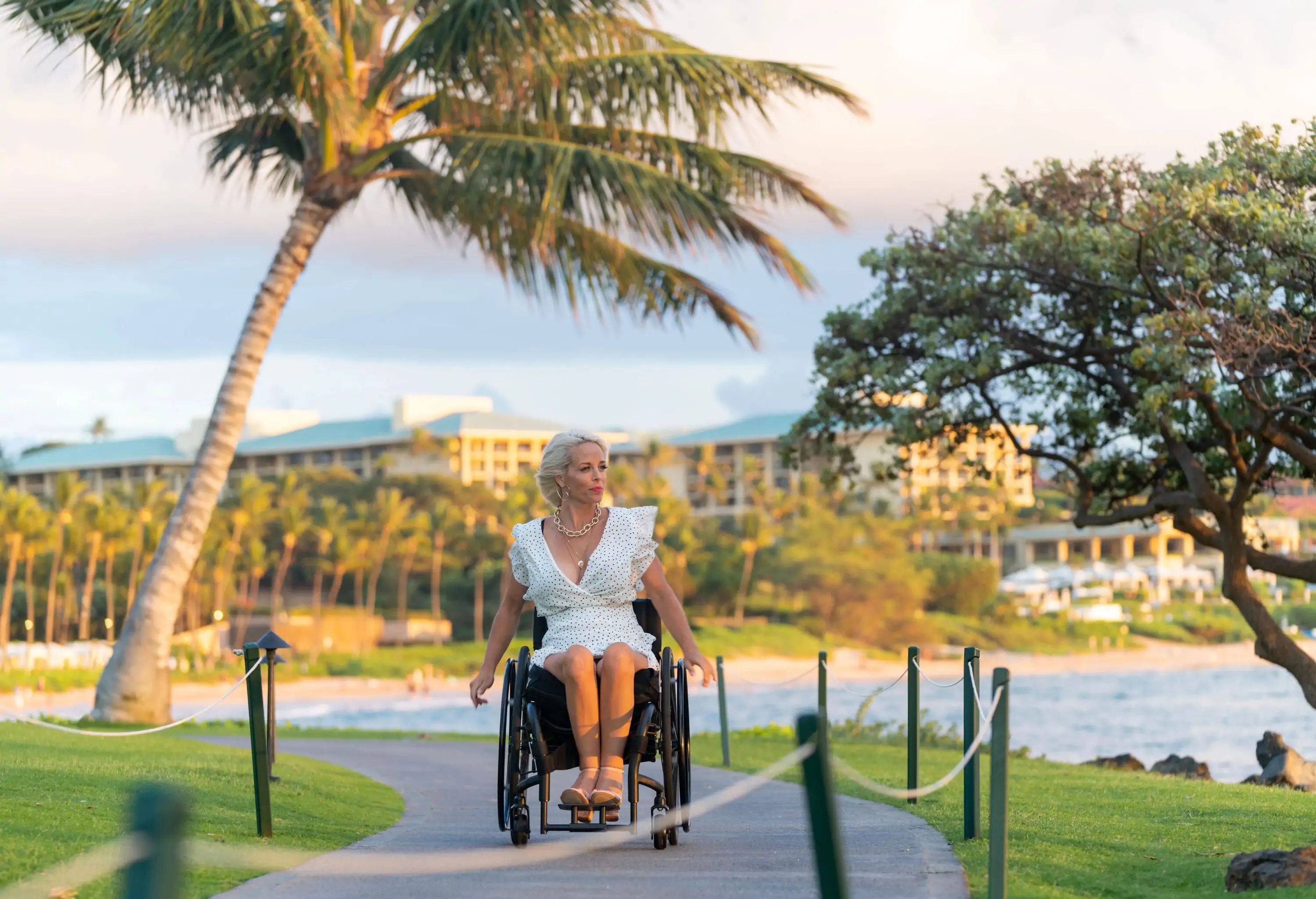Confident woman in a wheelchair on vacation in a tropical location