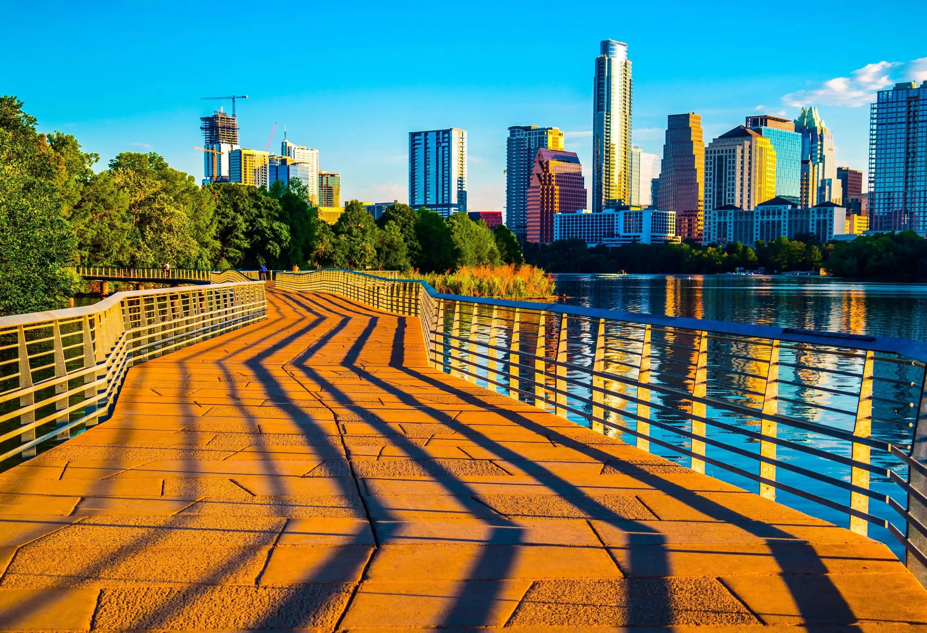 Austin Texas Abstract Skyline Cityscape as the sunrise hits the riverside pedestrian bridge modern architecture creates an amazing display of shadows across the bridge leading up to the skyline downtown