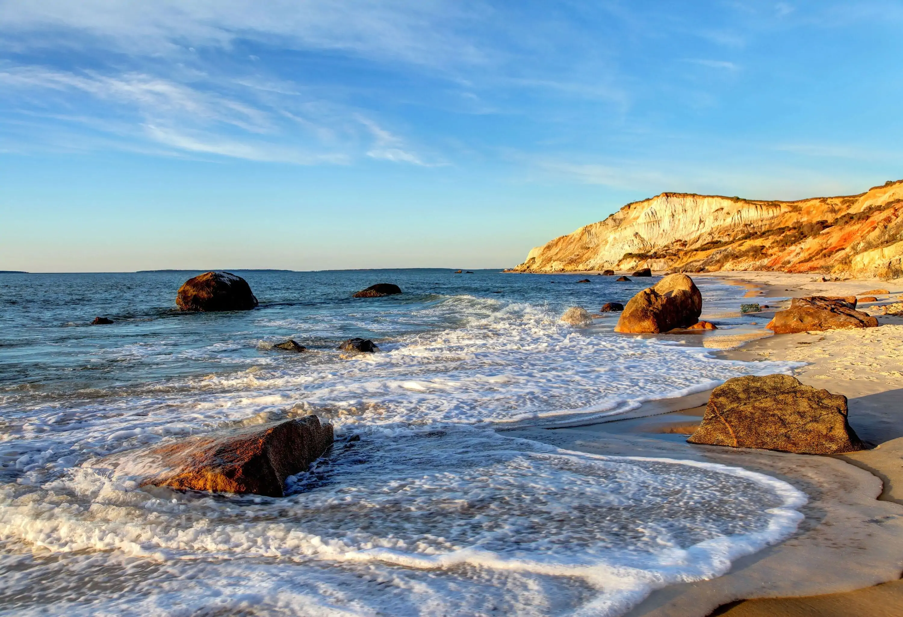 Low angle view of rocky beach at sunset