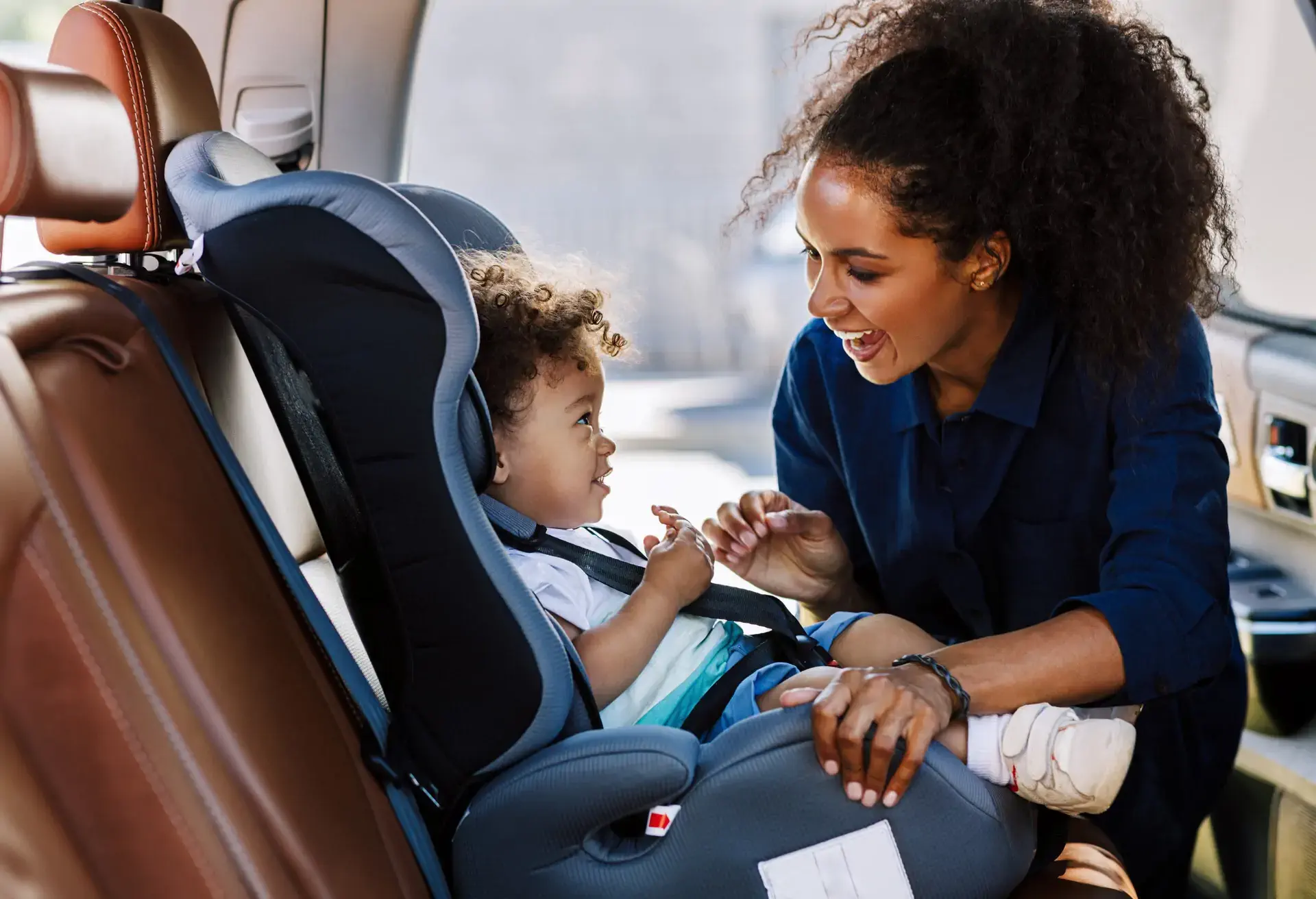 Mother safely preparing baby for a road trip