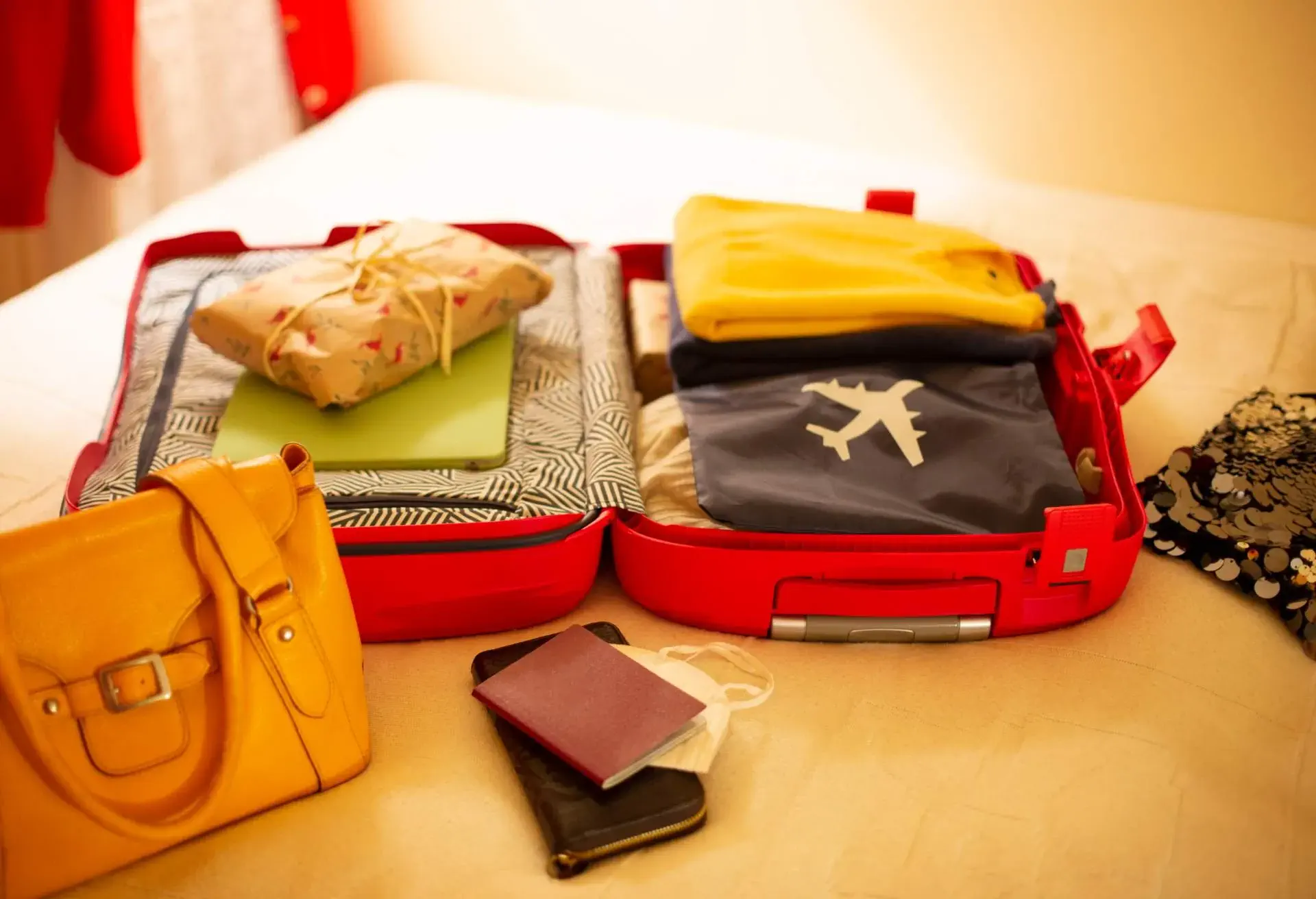 Packed suitcase lying open on bed