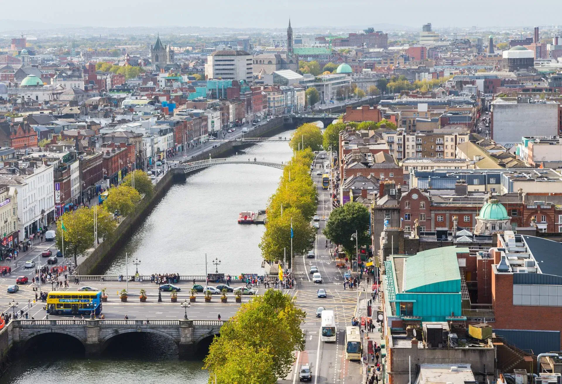 Numerous bridges cross a river that separates the town from its tree-lined streets.