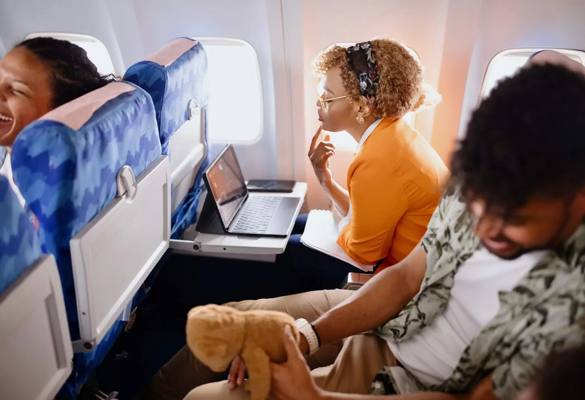 Passengers on a plane watching a movie