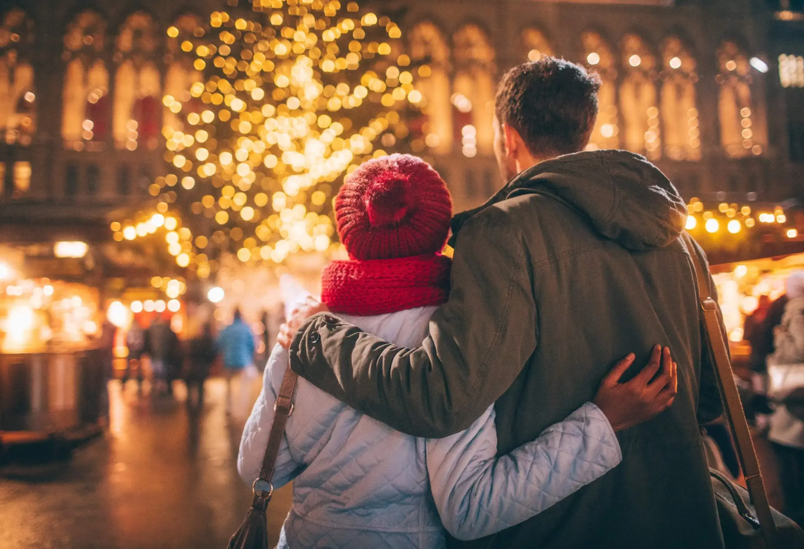 A sweet couple stopping to admire the Christmas decorations on the street.