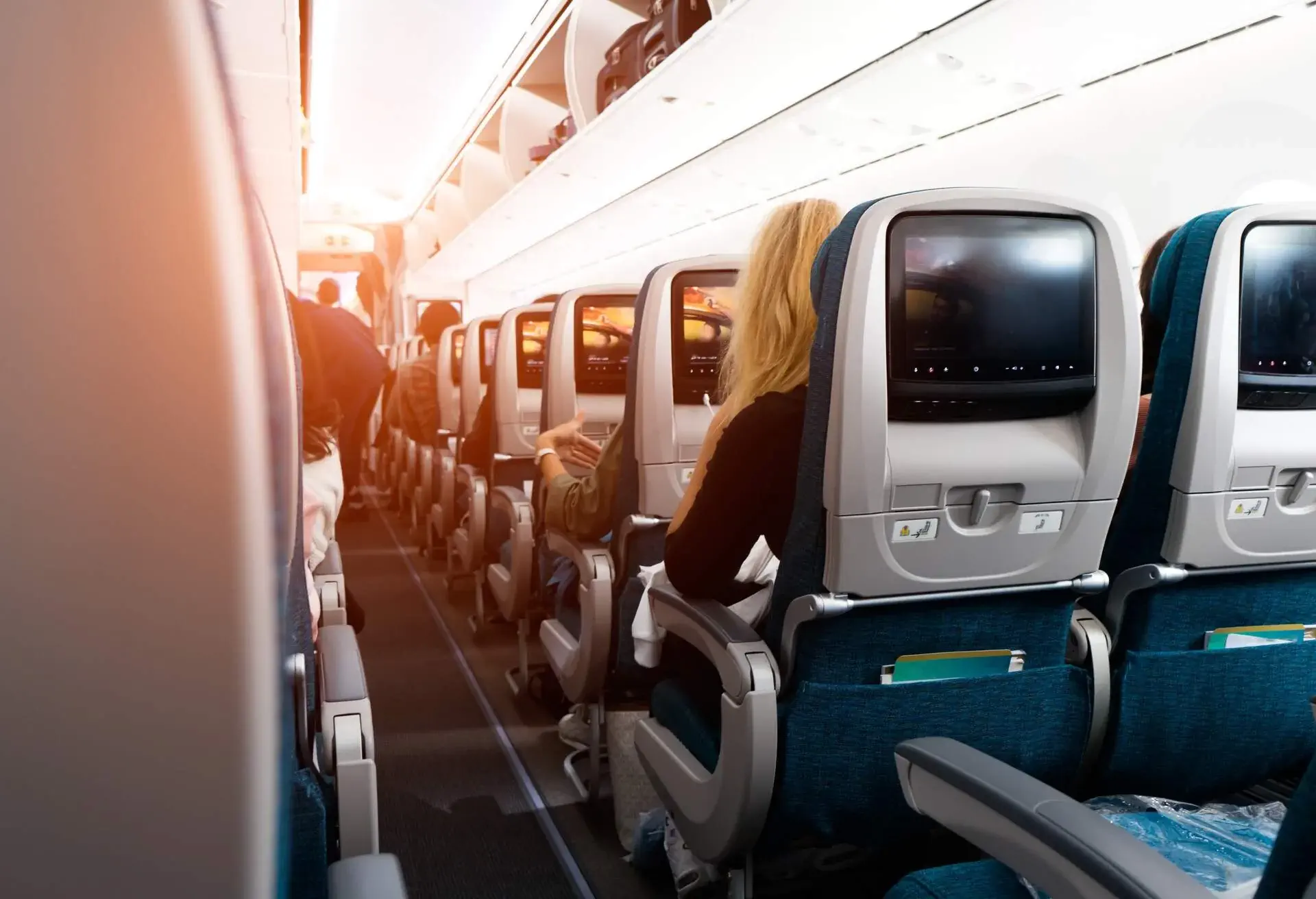 People seating on a plane in the last rows