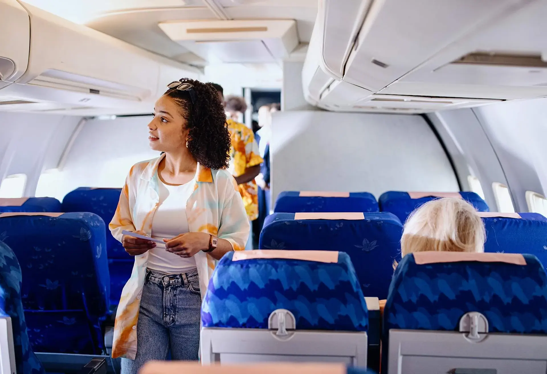 Passengers boarding plane and searching for their sets