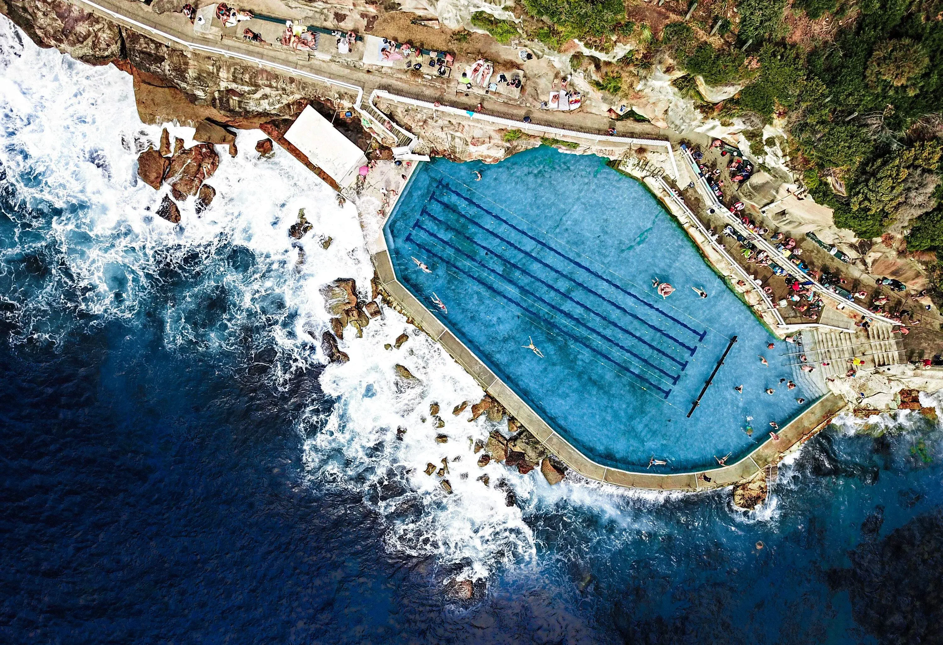 People crowd excitedly at the vantage point, eagerly taking in the stunning natural beauty of the seaside landscape.