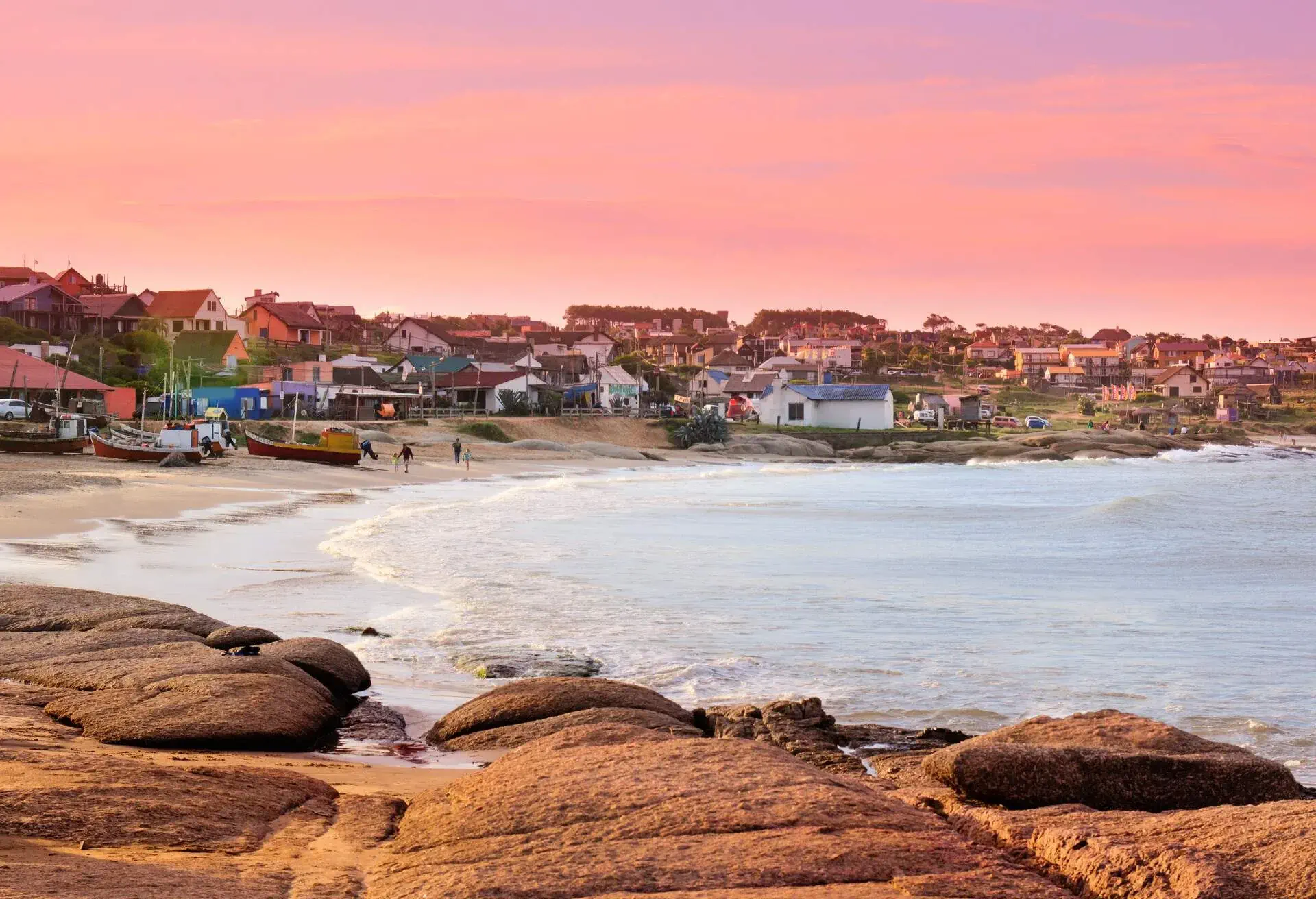 A coastal fishing village with old and colourful houses overlooking the tranquil sea under the scenic twilight sky.