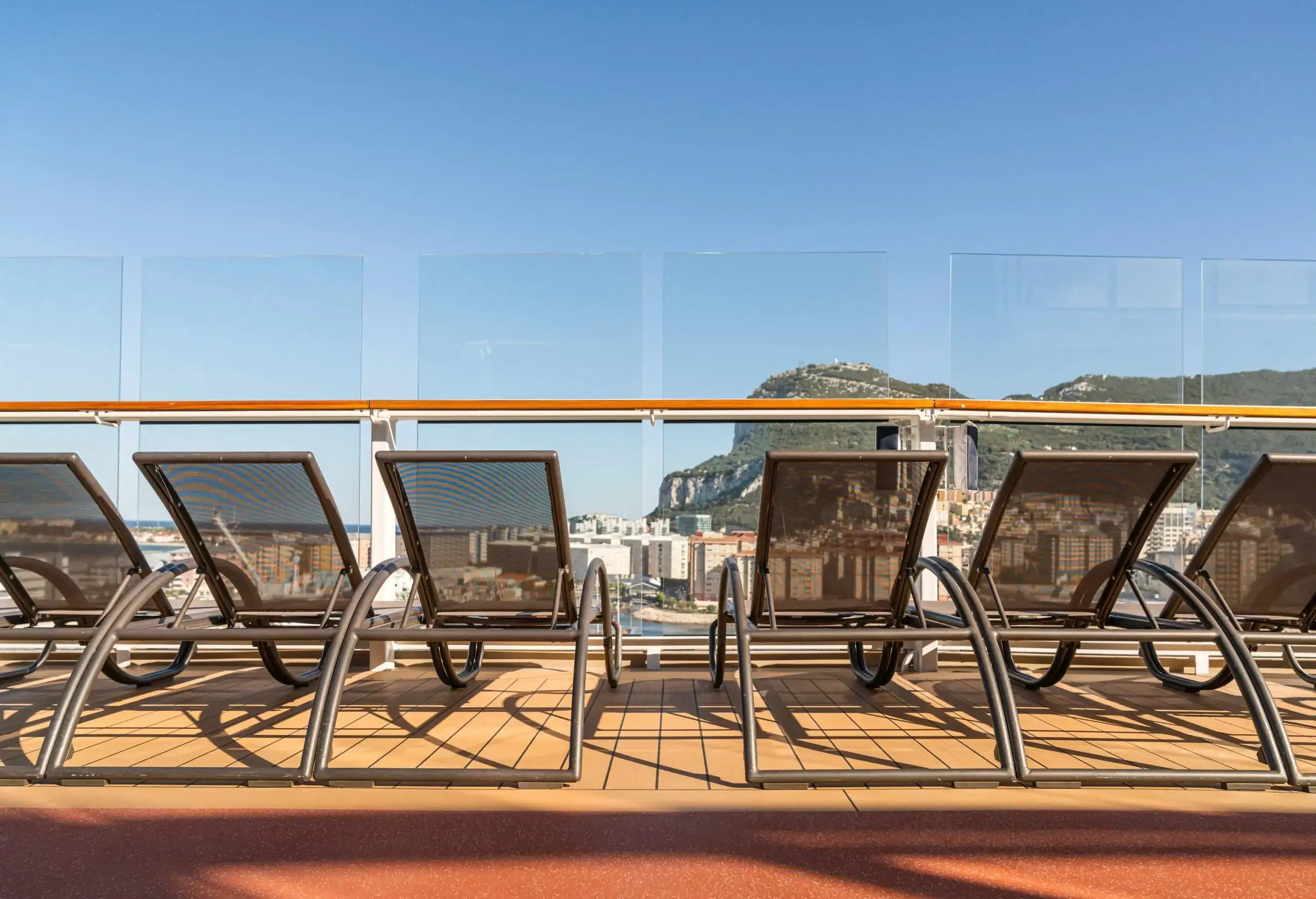 rows of empty sun bathing bench on board a cruise wooden deck sunset moment