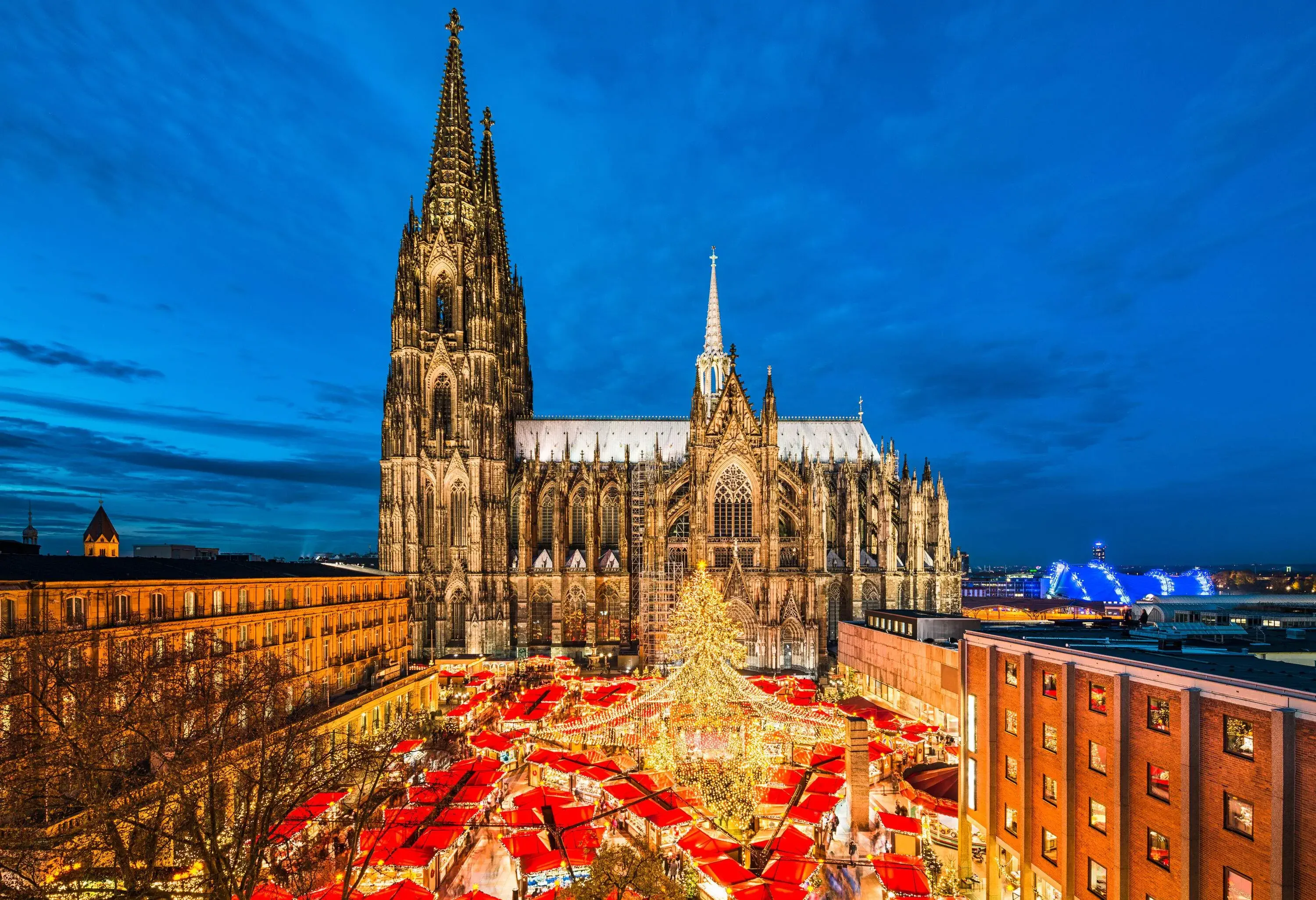 An imposing Gothic-styled cathedral with a brilliant Christmas market in the middle of its square.