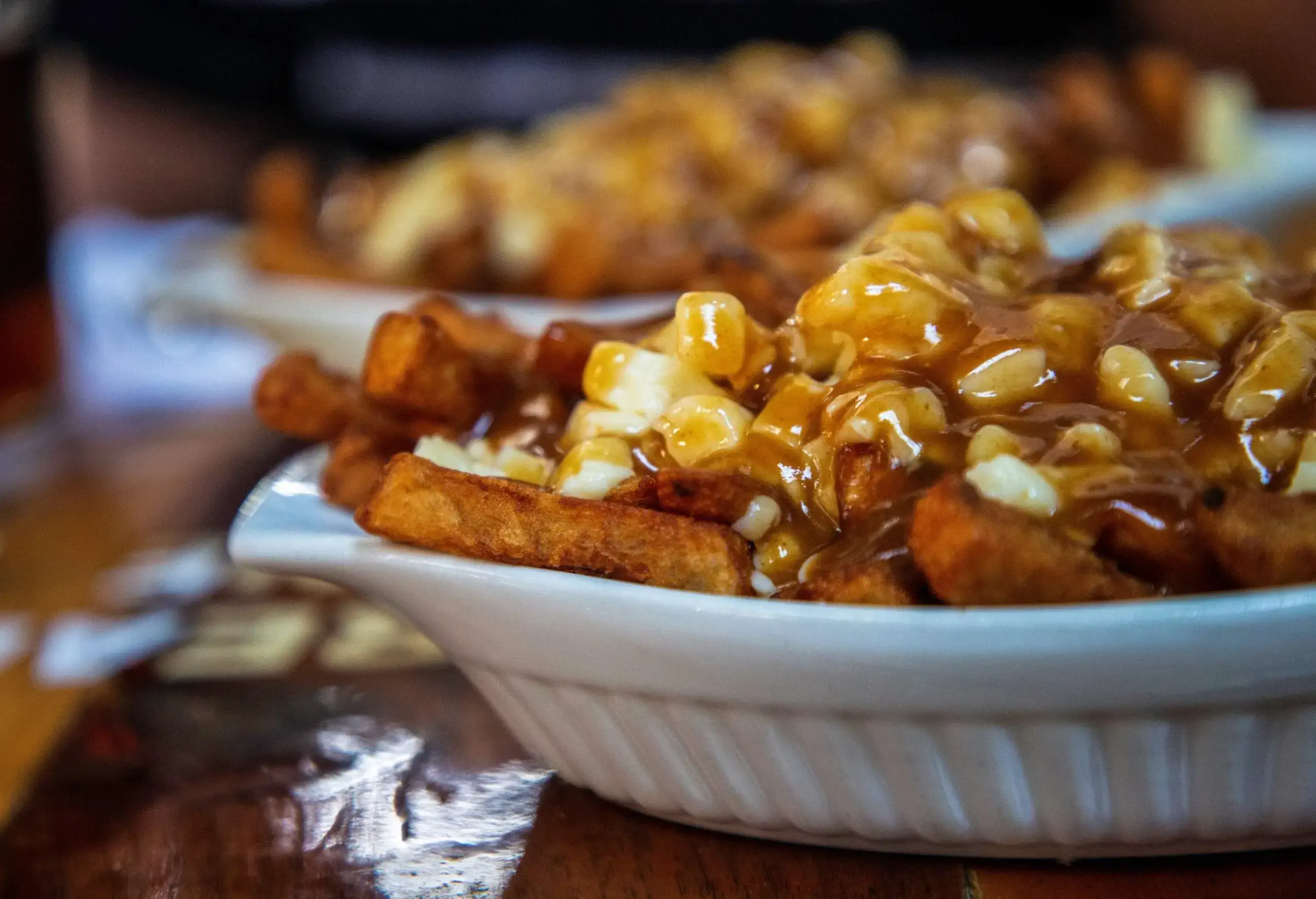 A comforting bowl of crispy fries smothered in savoury gravy and melted cheese curds.