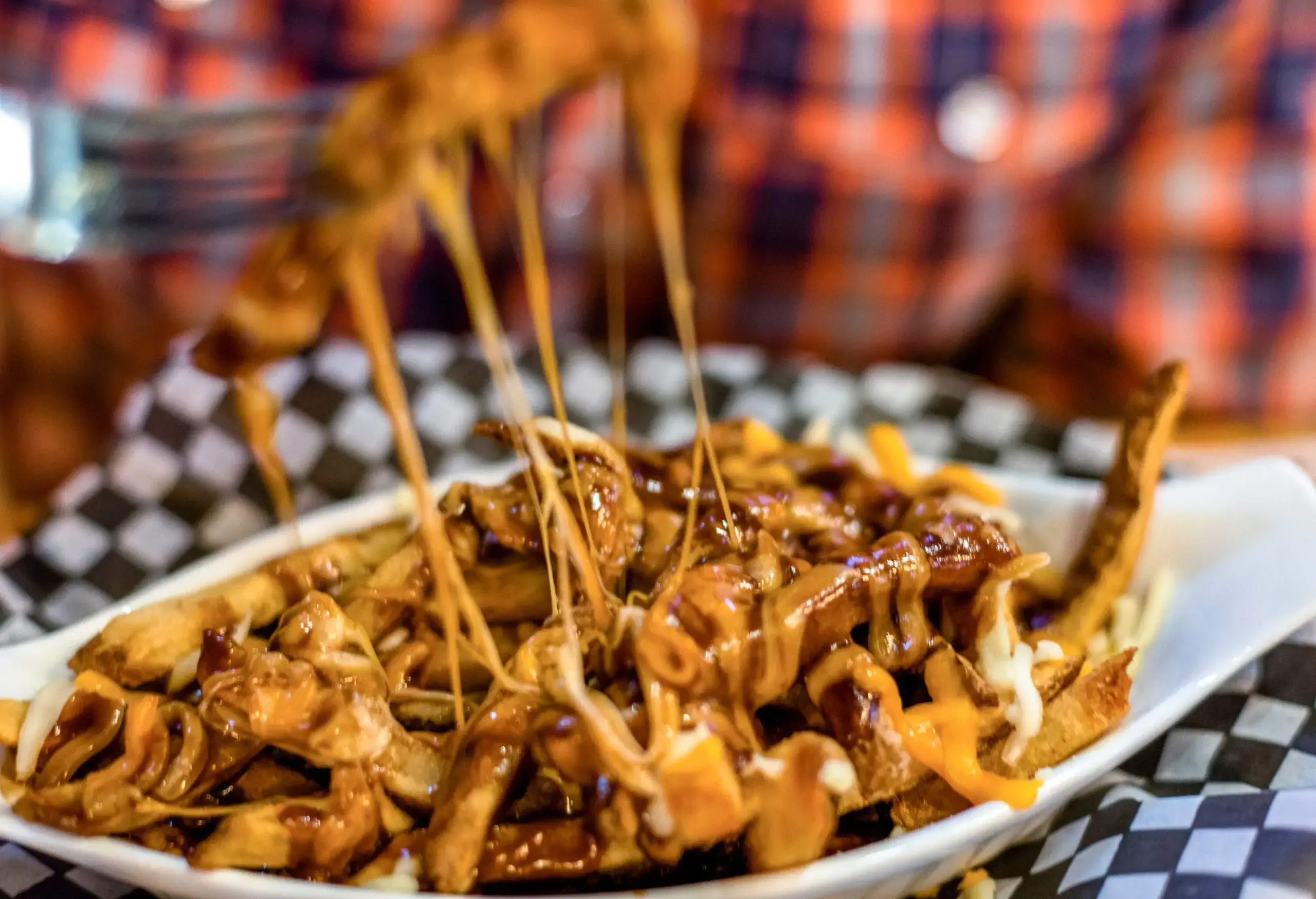 He picks up a cheesy bite with fork.