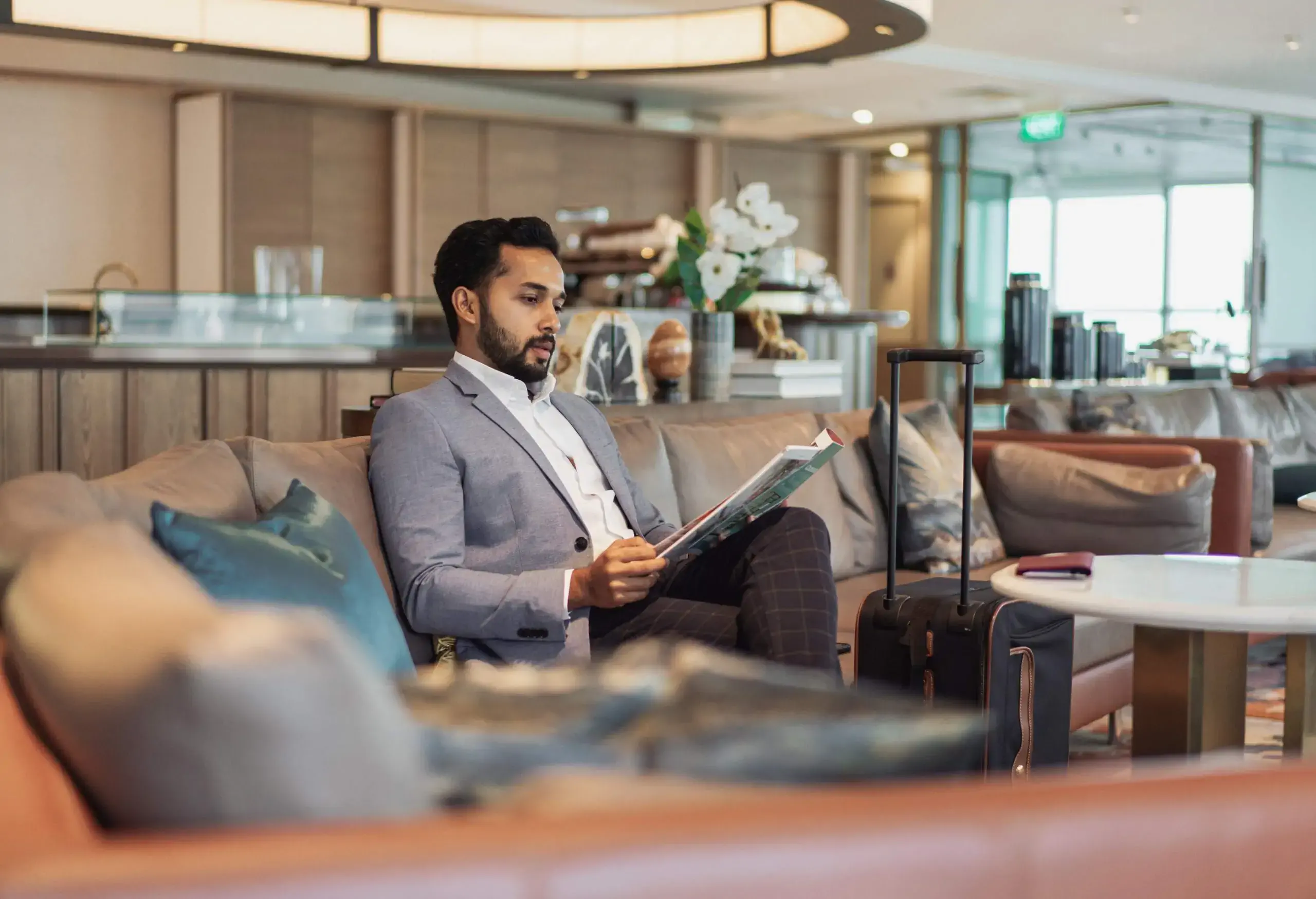 Business travel - businessman waiting in a lounge.