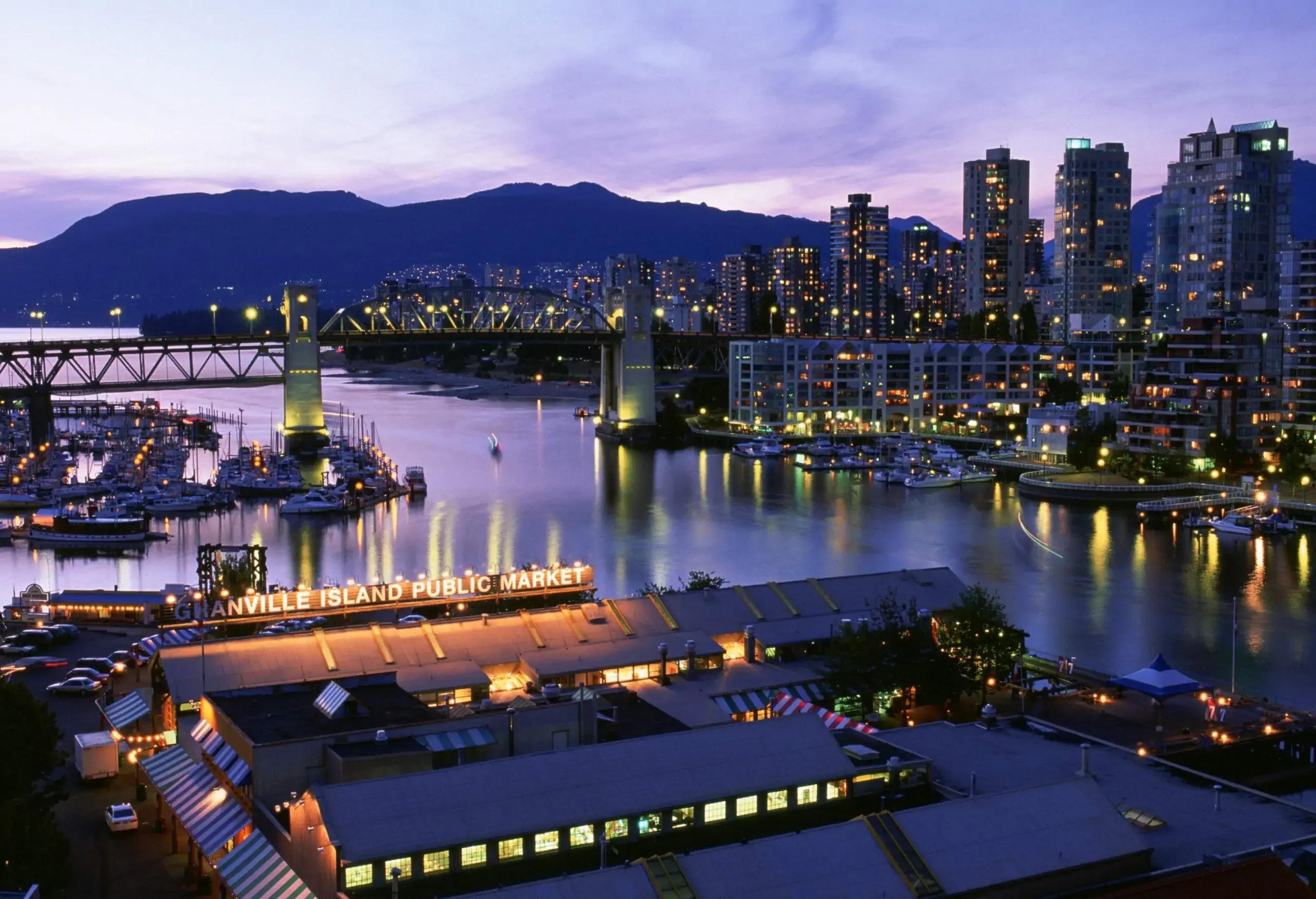 An Art Deco steel truss bridge crossing the False Creek provides access to the cityscape.