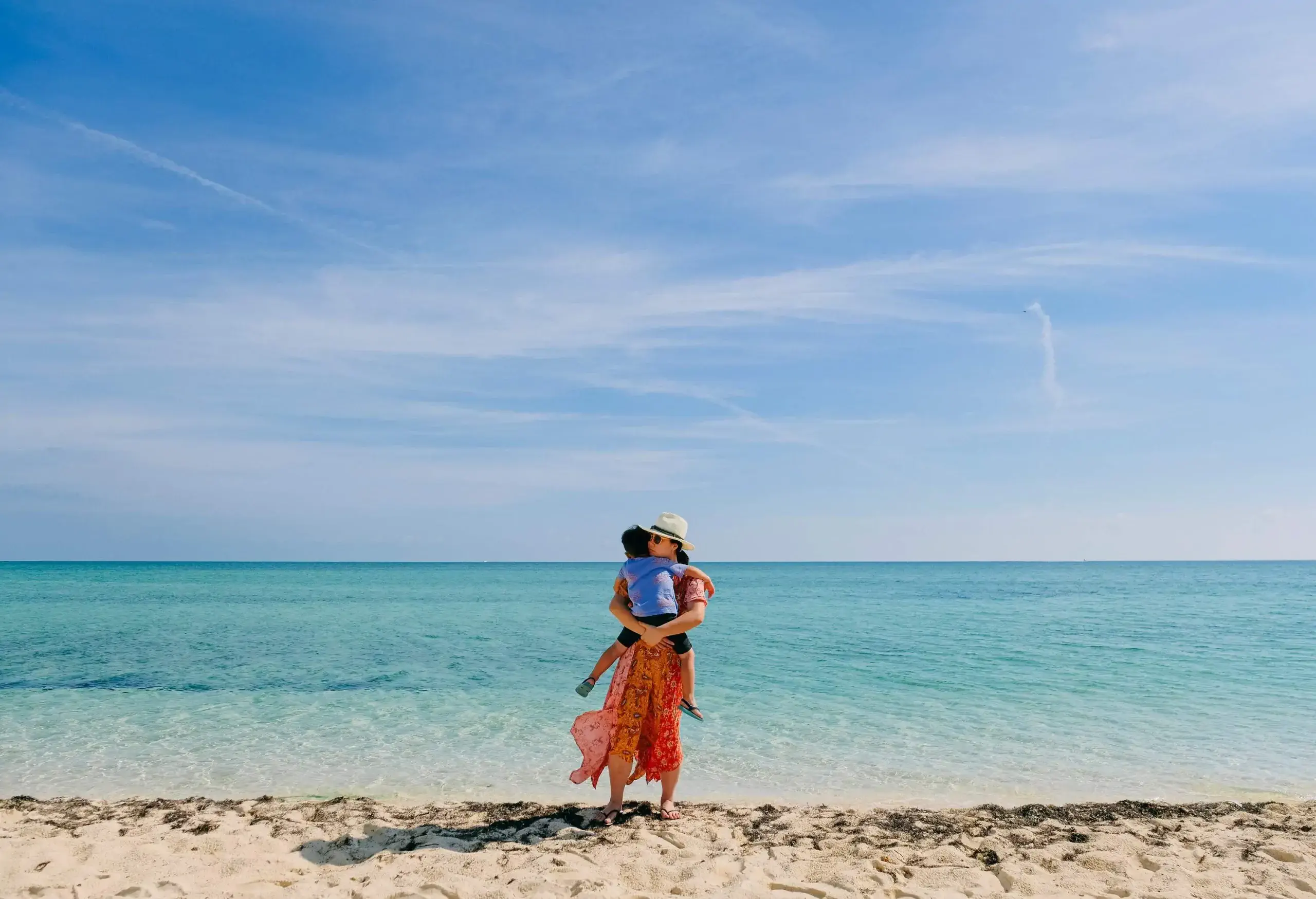 A mother and her child enjoy the beach in Nassau, Bahamas.