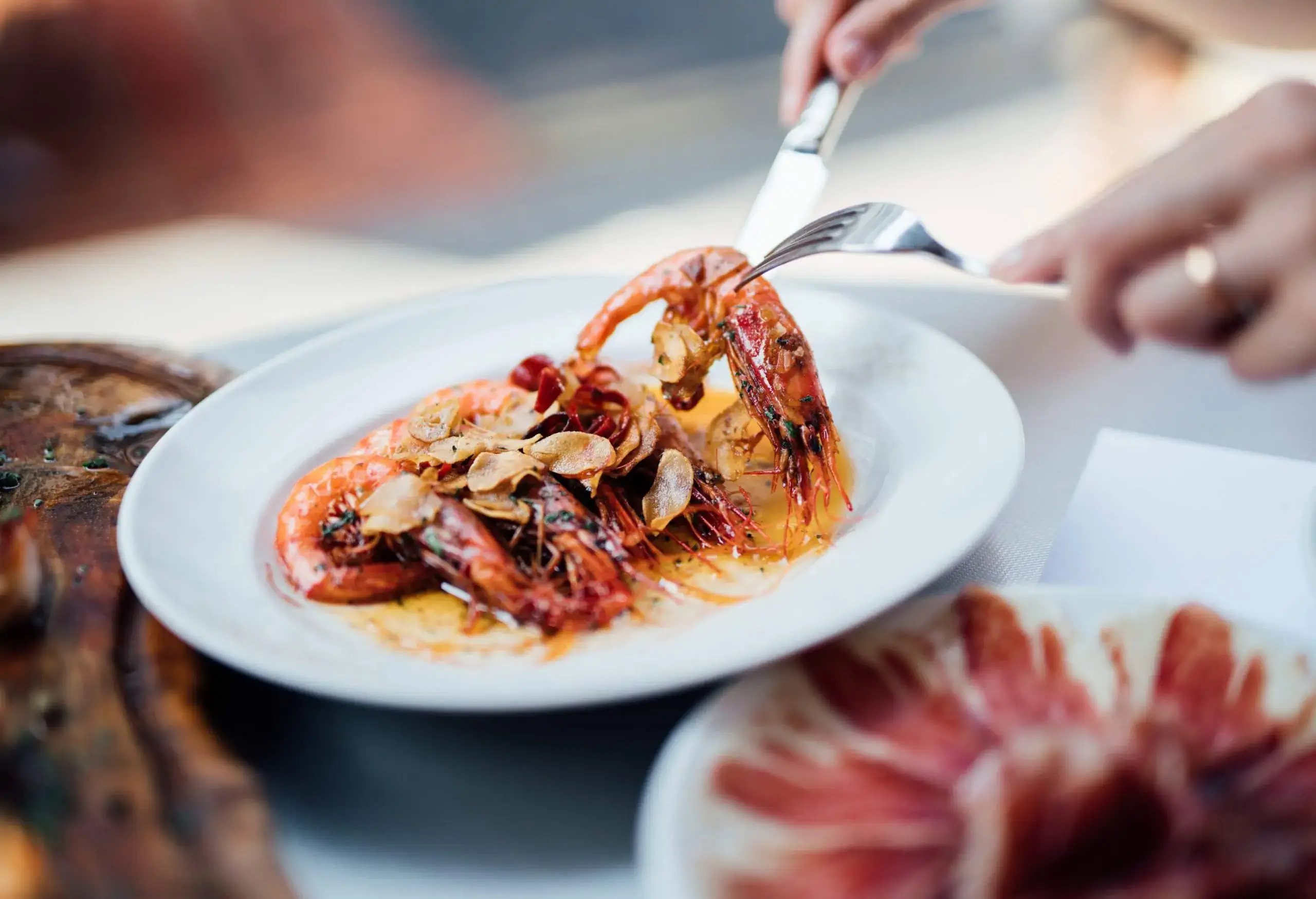 Grilled prawns in oil on a white plate. 