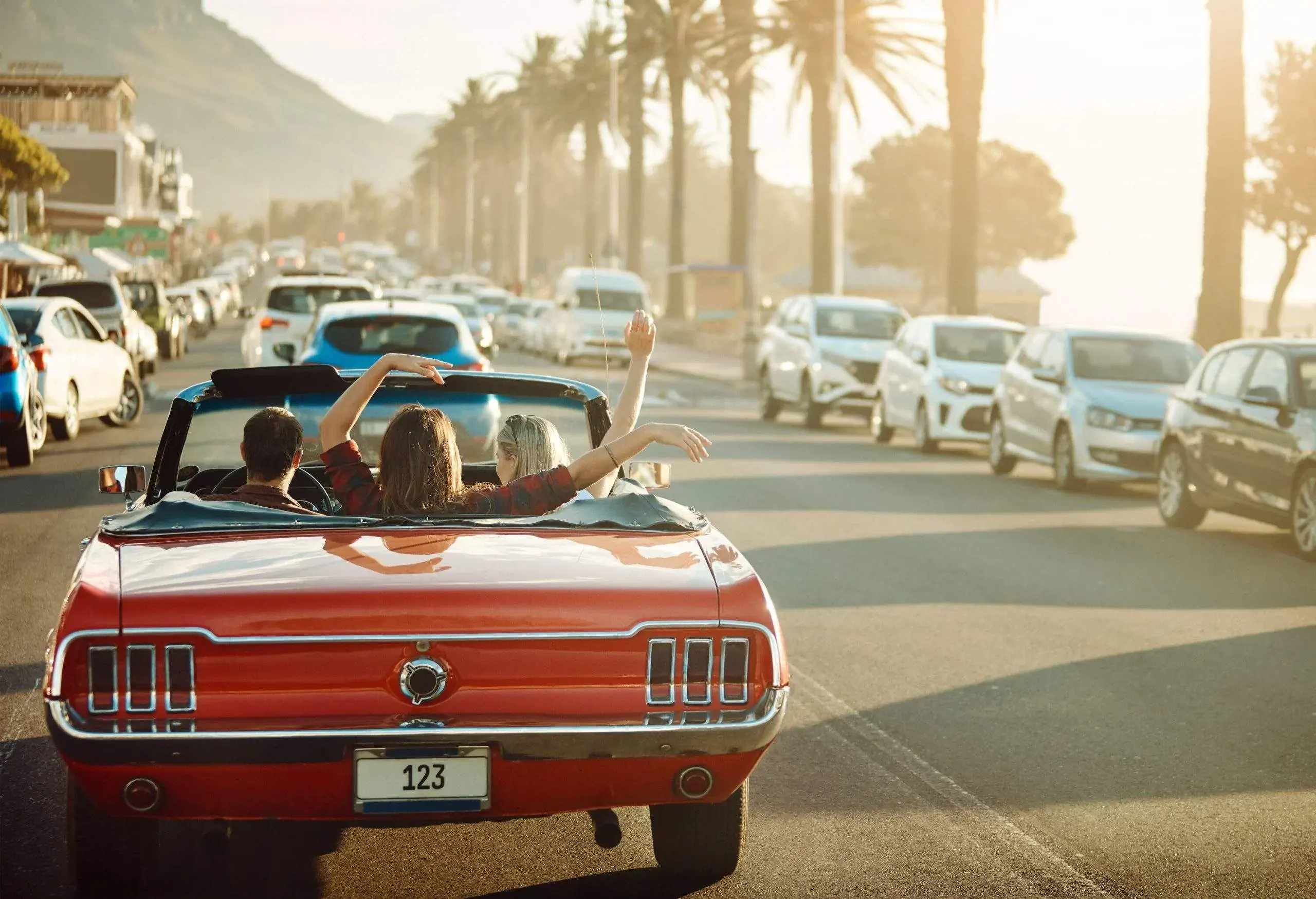theme_car_vehicle_convertible_sunset_people_vacation-gettyimages-1148606069-scaled