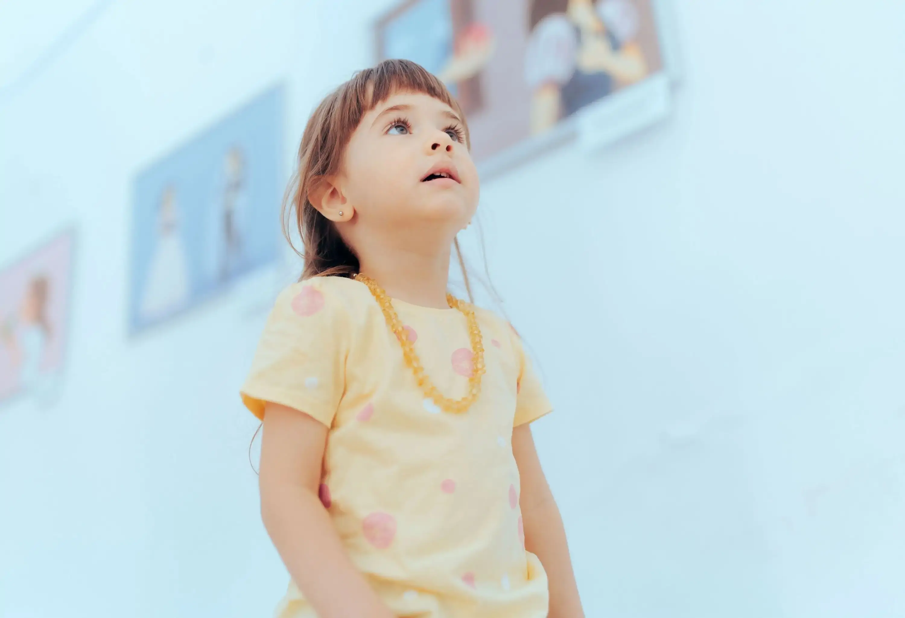 A little girl stares blankly at the exhibits in the museum.