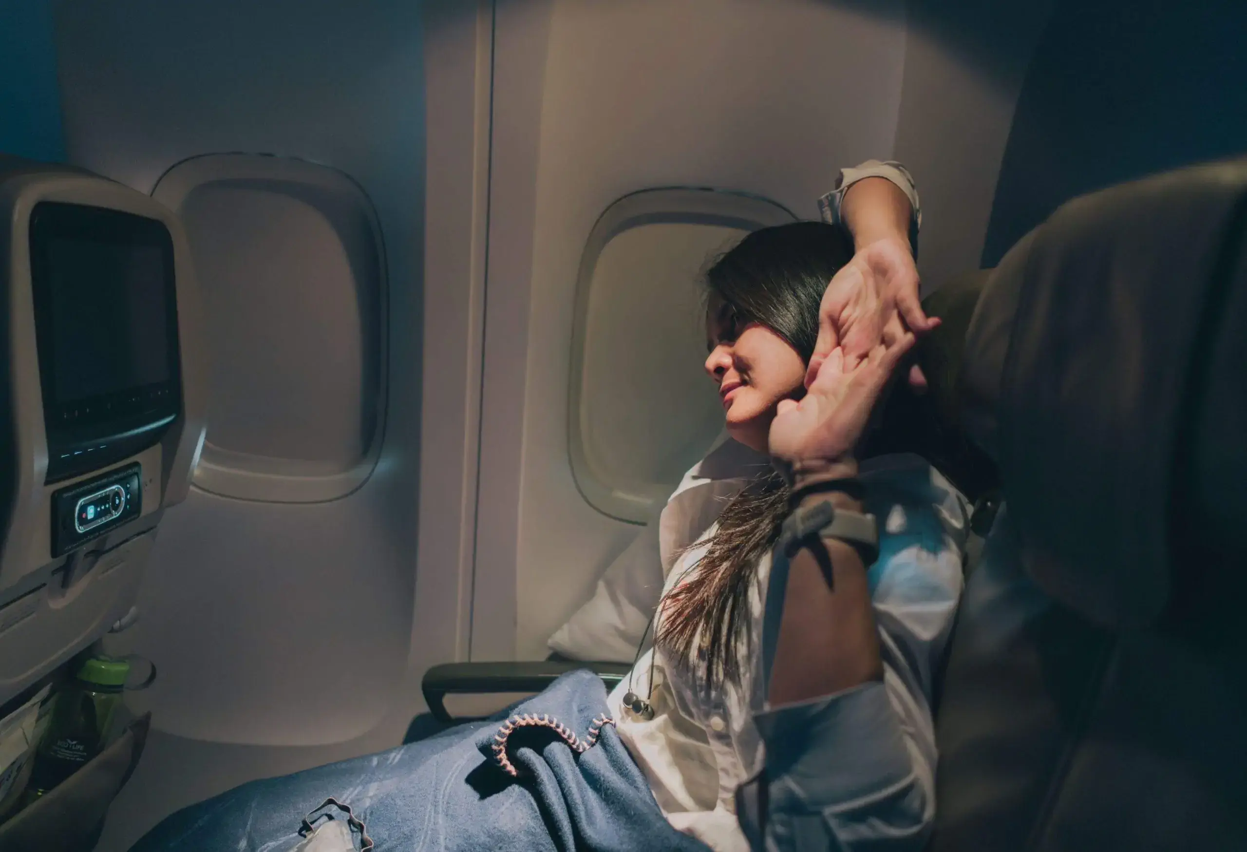 Woman stretching on long haul flight