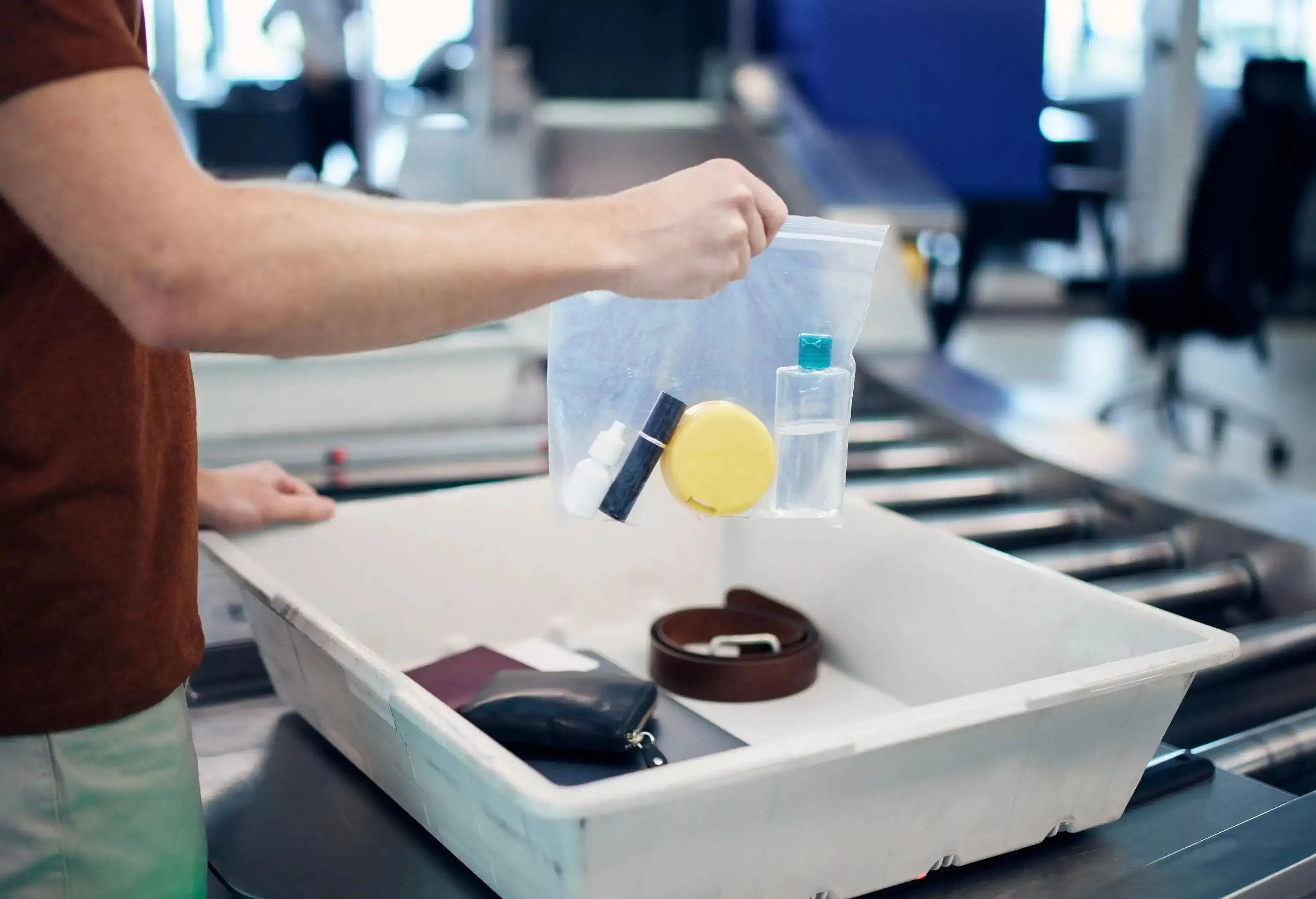 A man packing his liquids into a plastic bag at the airport security check point