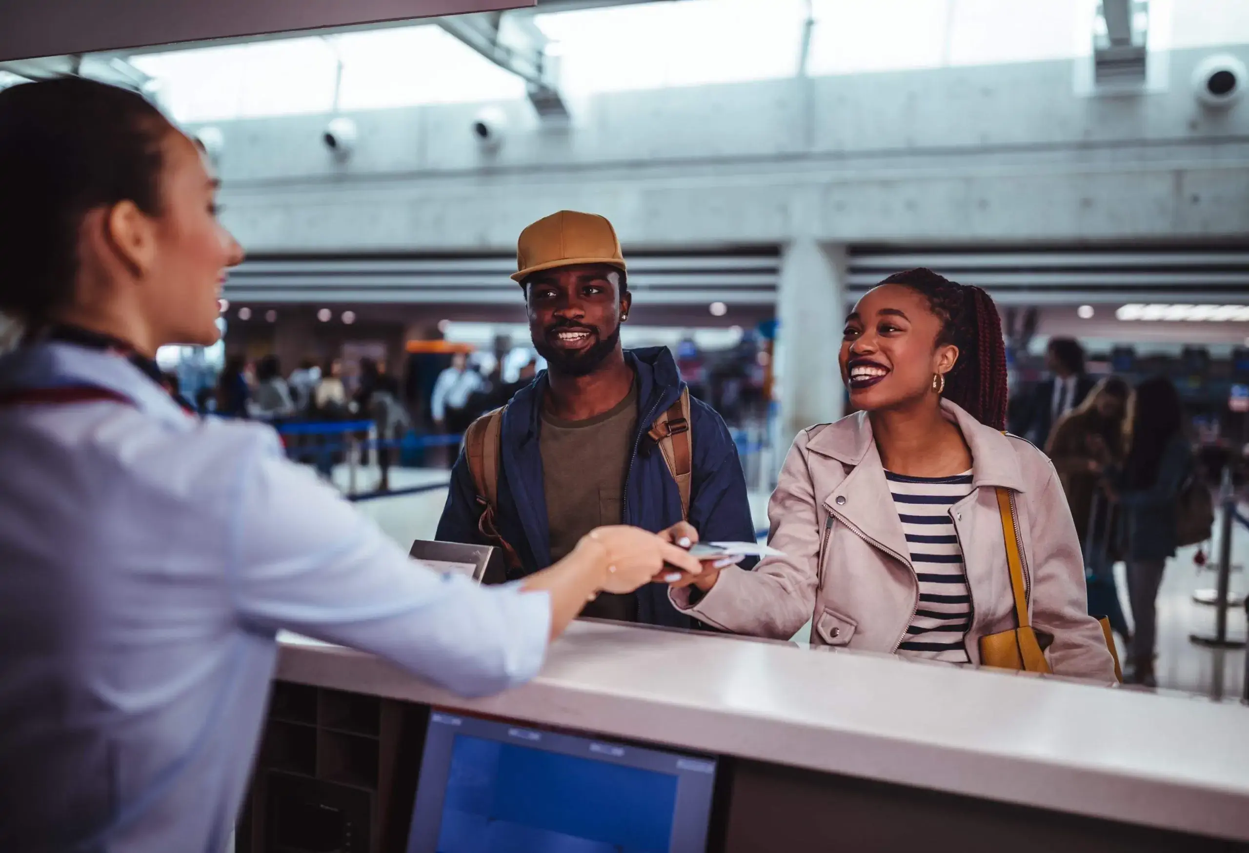 A couple at the ticket desk at the airport.